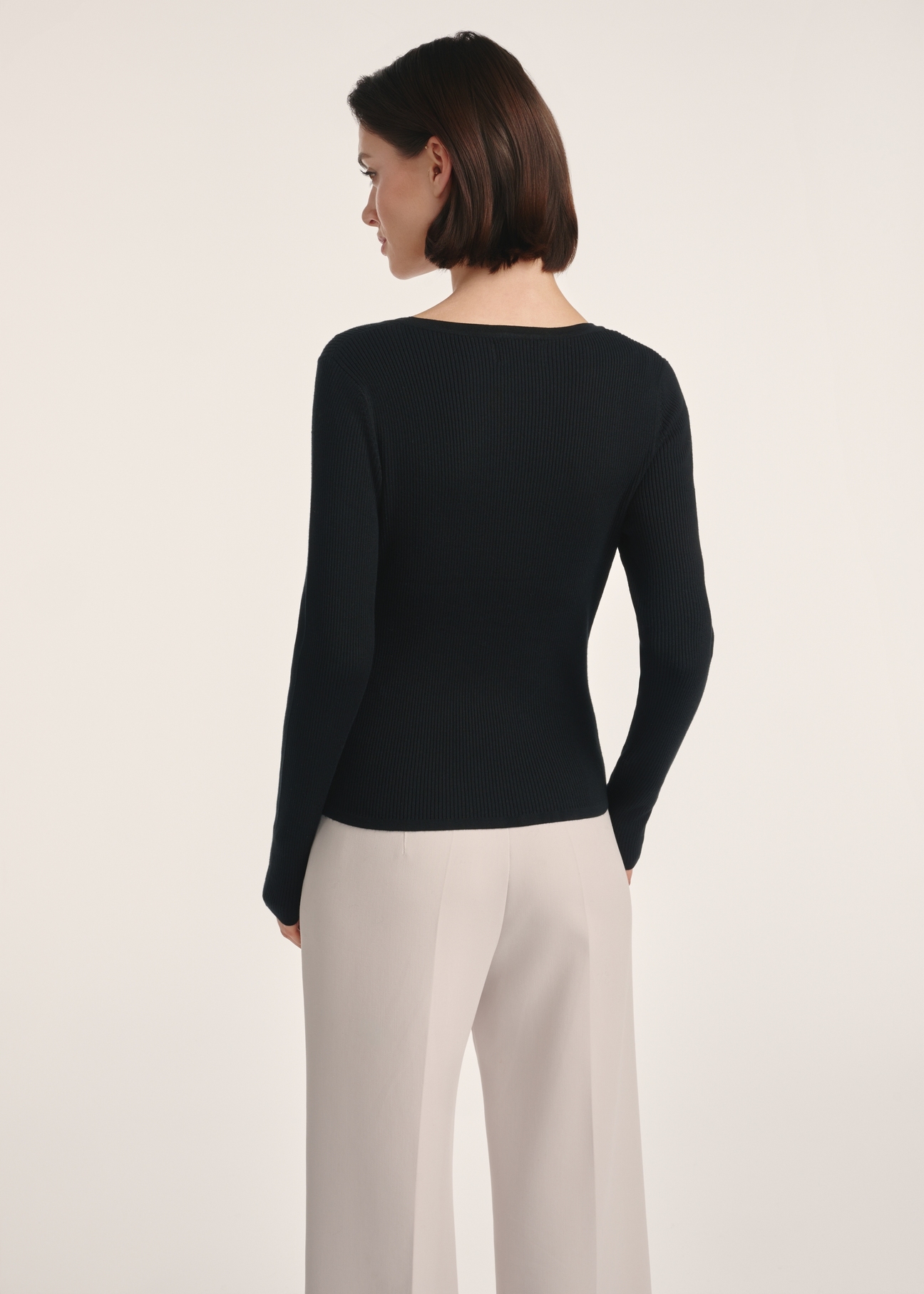 Black women's long sleeve blouse LSLDT-0051-99(Z25), product view from the back on the model. Half of the silhouette visible.