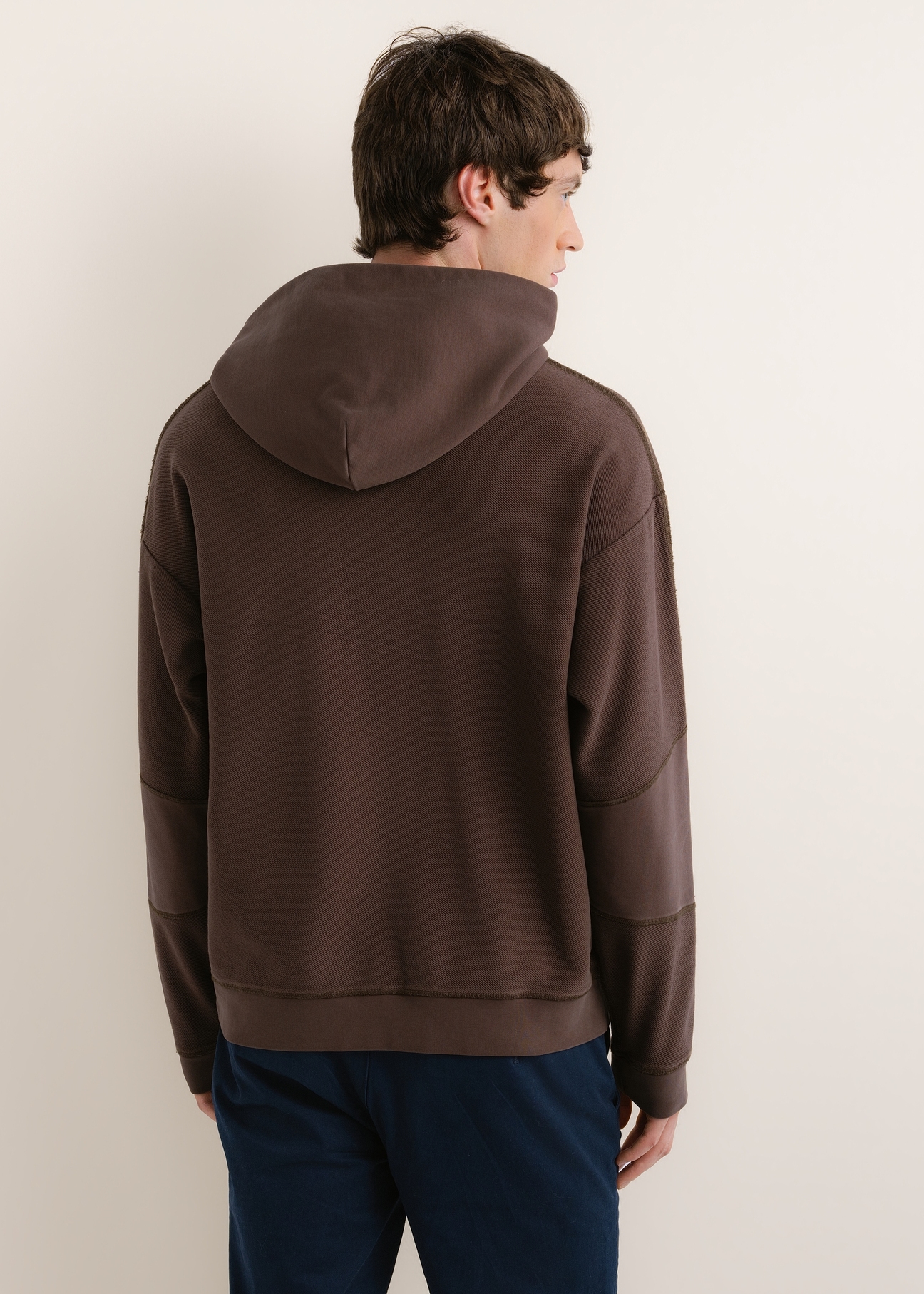 Dark brown men's cotton hoodie BLZMT-0086-1I(Z26), view of the product from the back on the model. Half of the silhouette visible.