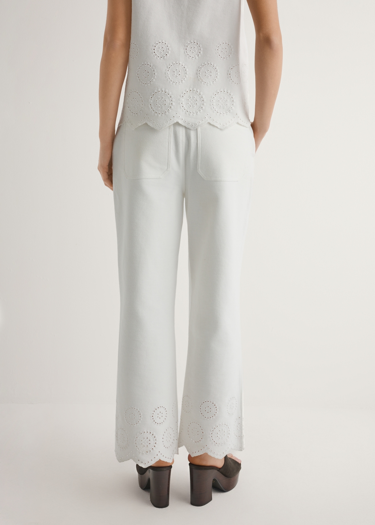 Women's white wide leg trousers SPODT-0122-0B(W26), back view of the product on the model. Half of the silhouette visible.