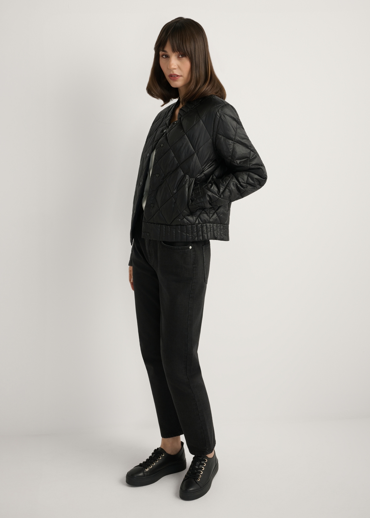 Women's black transitional jacket KURDT-0564A-99(W26), side view of the product on the model. Full body visible.