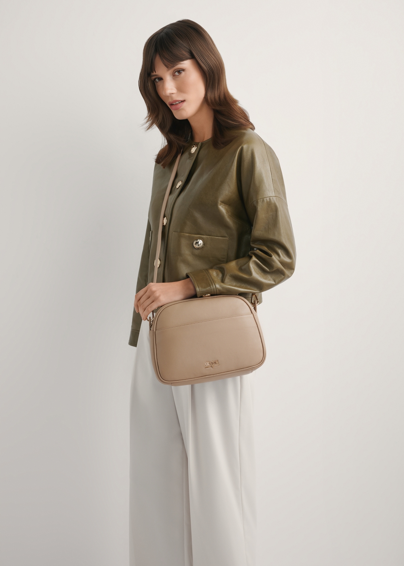Beige leather women's shoulder bag TORES-0806F-1B(W26), product view on model's shoulder. Half of silhouette visible.