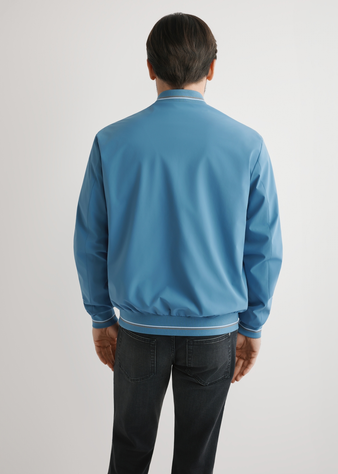 Men's blue nylon jacket KURMT-0416-7C(W26), product view from the back on the model. Half of the silhouette visible.