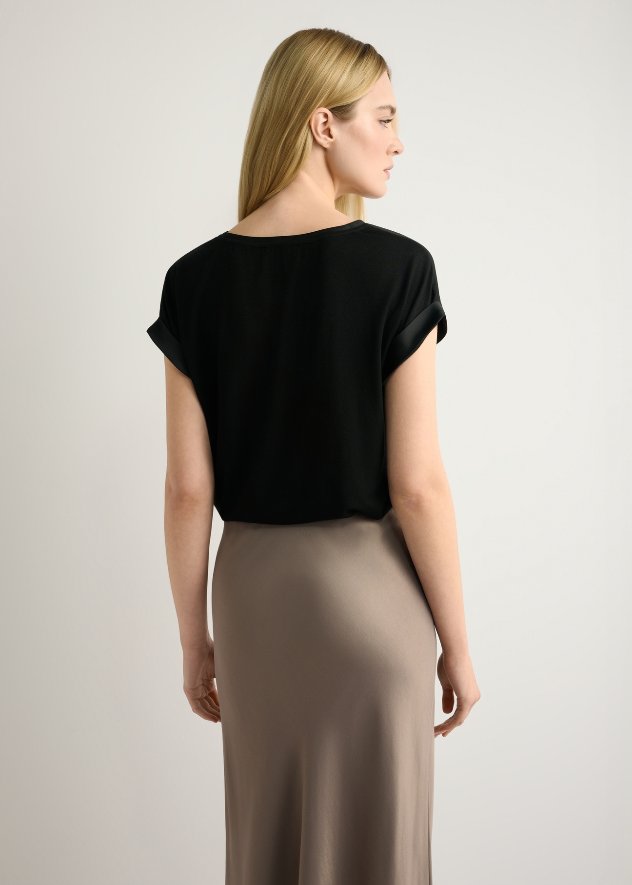 Black women's blouse BLUDT-0205-99(W26), back view of the product on the model. Half of the silhouette visible.