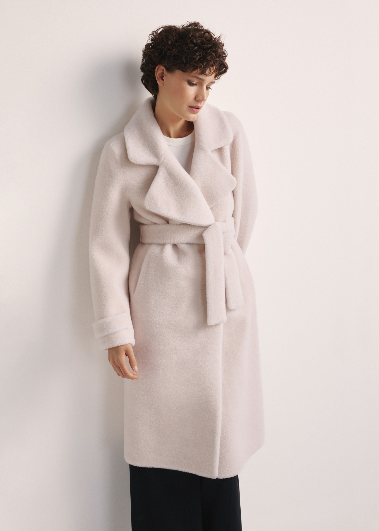 Long woolen fur coat in cream color FUTDW-0019A-12(Z25) - front view of the product on a white background. Half of the silhouette visible.