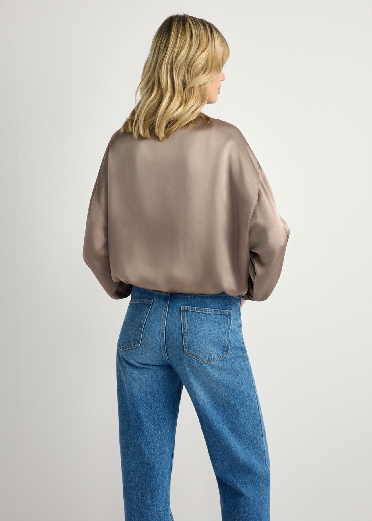 Light beige women's bomber jacket KURDT-0627-1K(W26) - back view of the product on a model, against a light background. Knee-length silhouette visible.