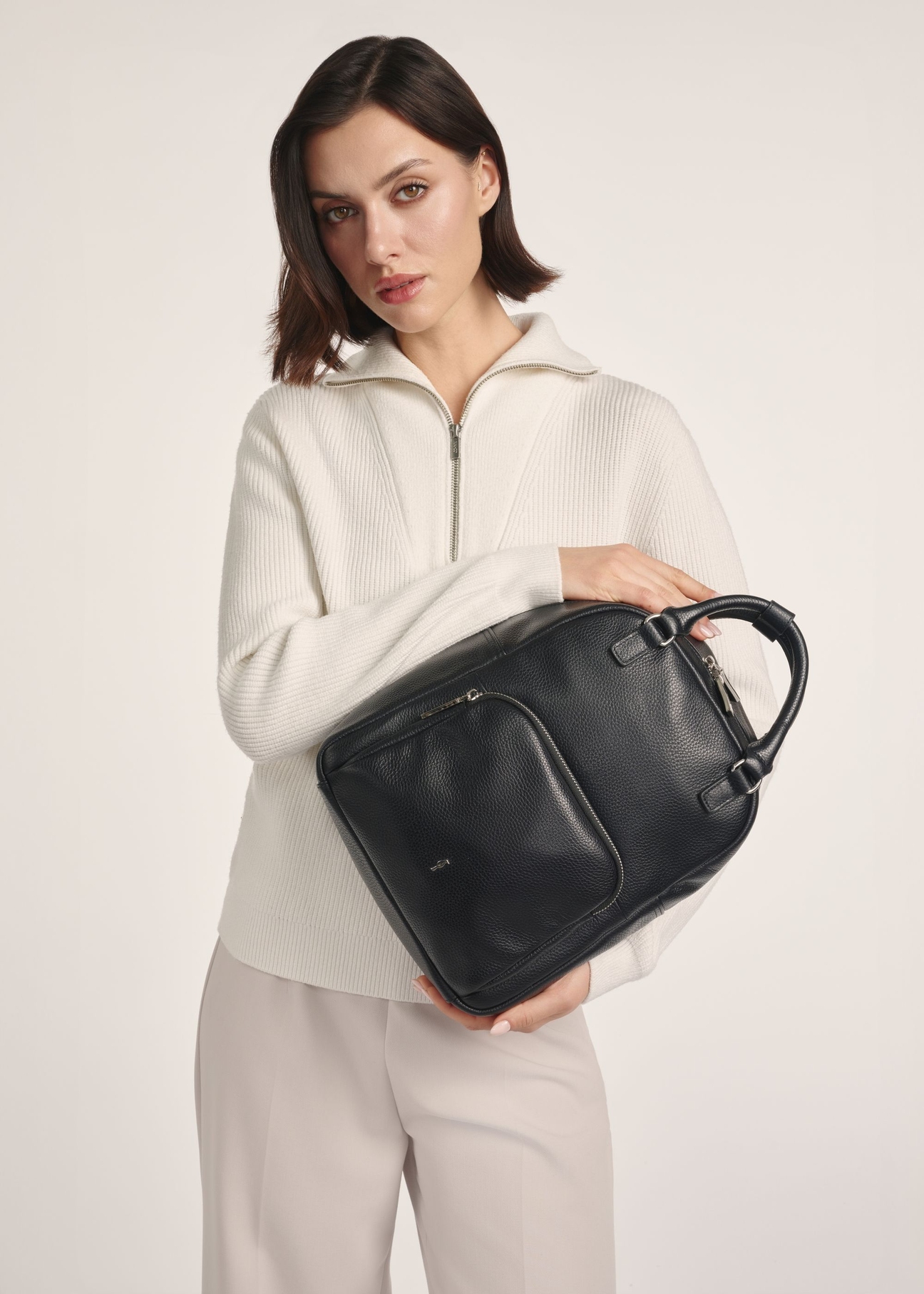 Women's black leather backpack TORES-1146-9I(Z26) - product visible from the front on the model, half of the silhouette visible.