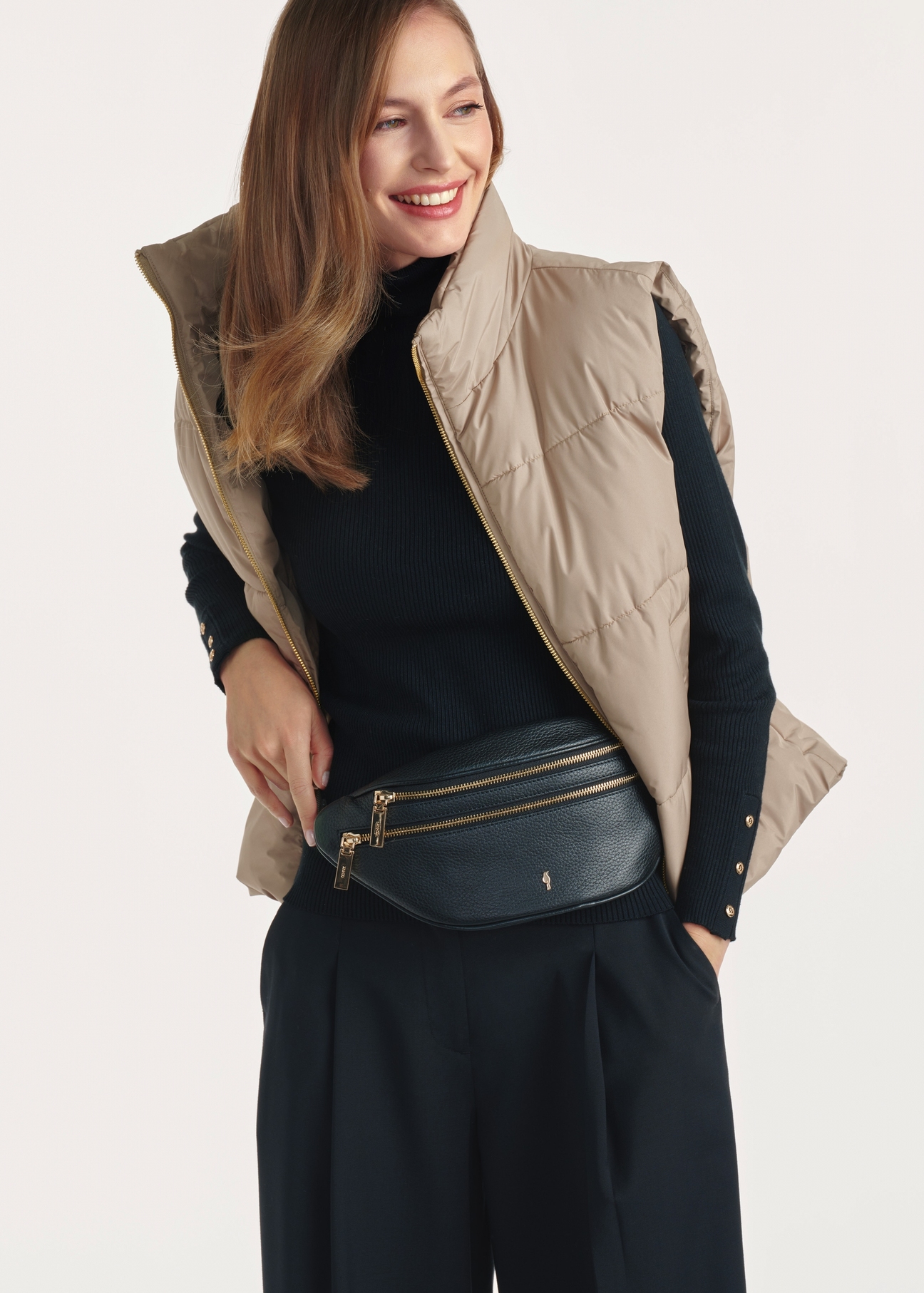 Women's black leather waist bag TORES-0721D-99(Z25), product view on a model, half of the silhouette visible.