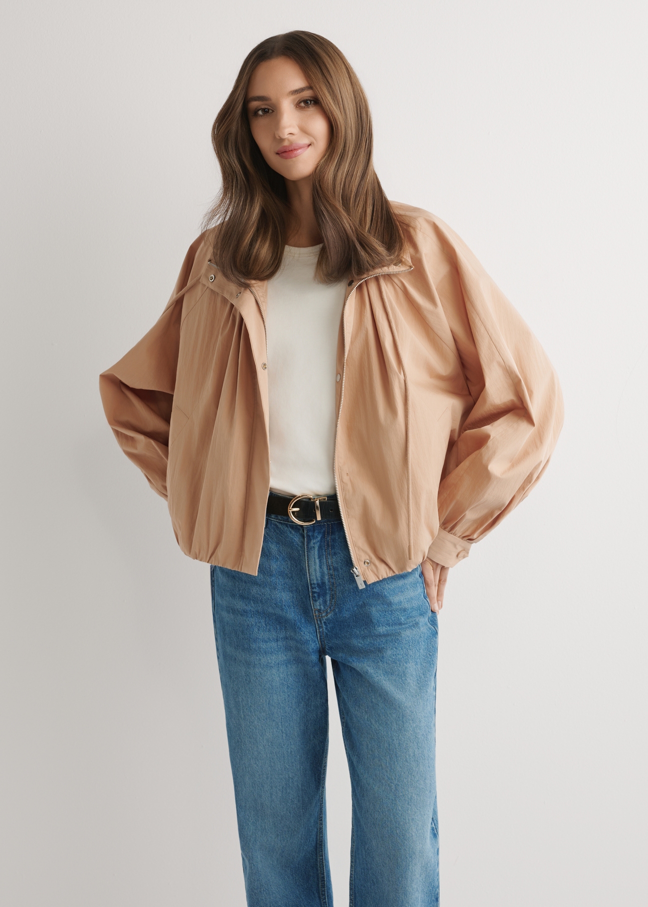 Beige short oversize women's jacket KURDT-0626-1D(W26) - front view of the product, on a model, against a light background. Knee-length silhouette visible.