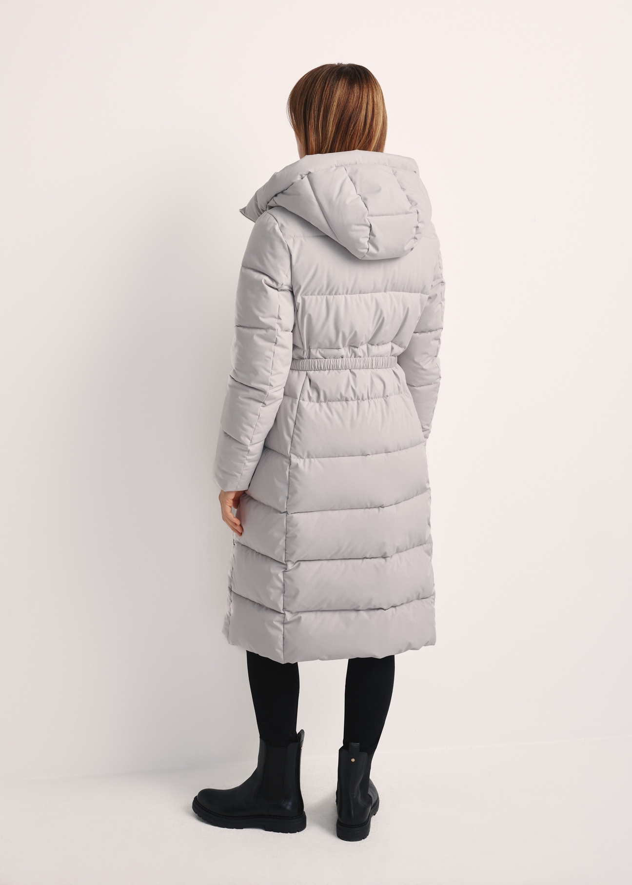 Long light gray women's jacket KURDT-0602-66(Z25), product view from the back on the model. The whole silhouette is visible.