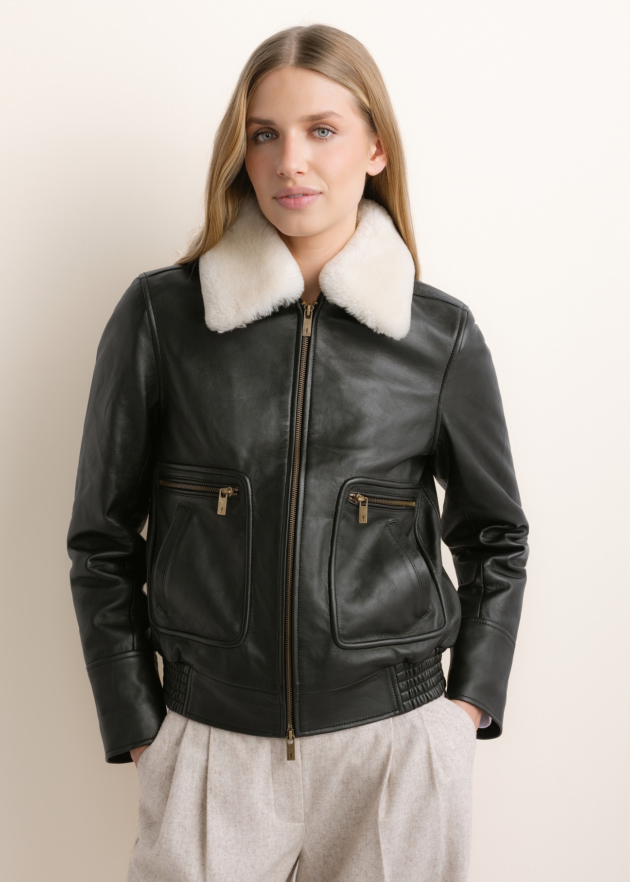 Black leather bomber jacket KURDS-0646-99(Z26), front view on a model. Half-body shot.