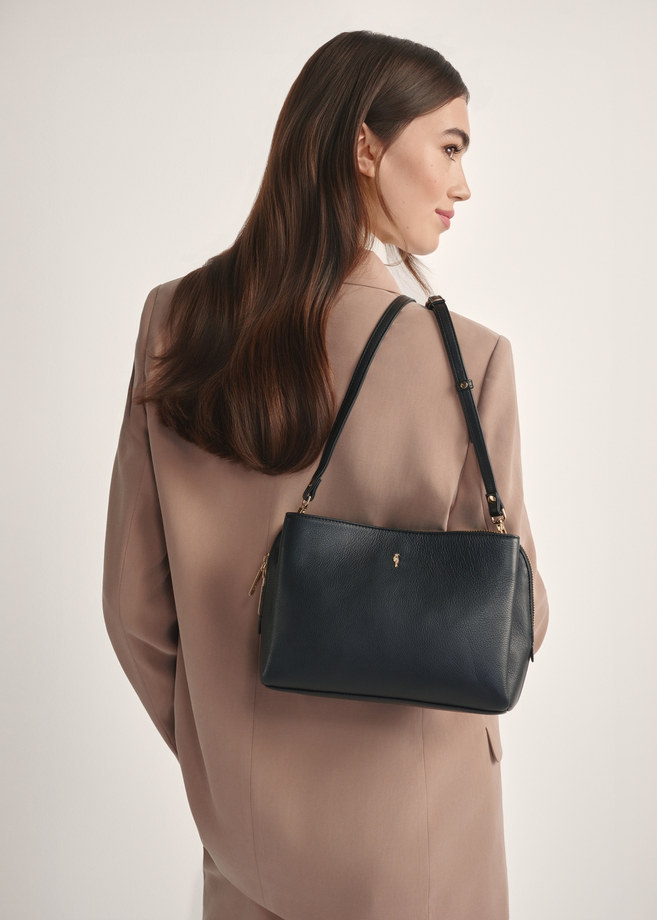 Black leather women's shoulder bag TORES-1244-99(W26), front view of the product on a model, half of the silhouette visible.