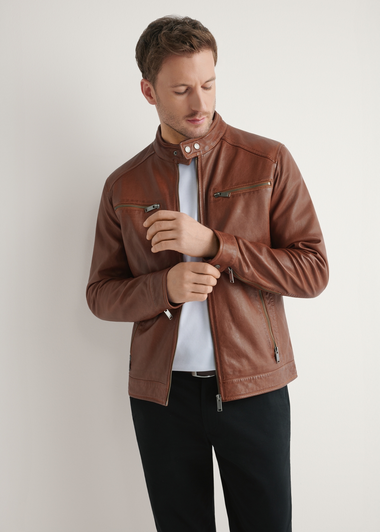 Light brown men's leather jacket KURMS-0326-1G(W26), front product view on model. Half silhouette visible.