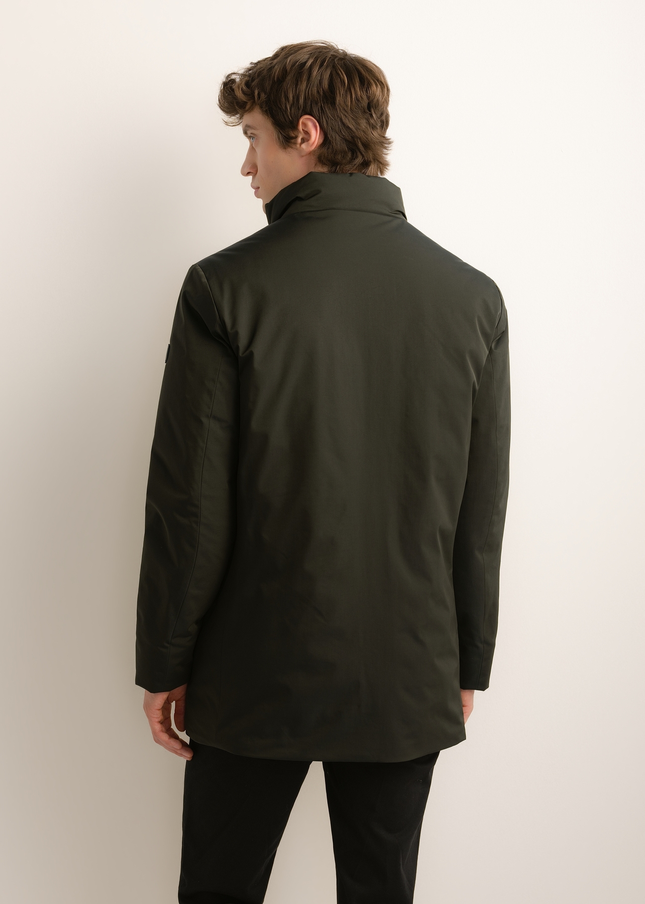 Green men's long winter jacket KURMT-0432-8B(Z26), product view from the back on the model. Half of the silhouette visible.
