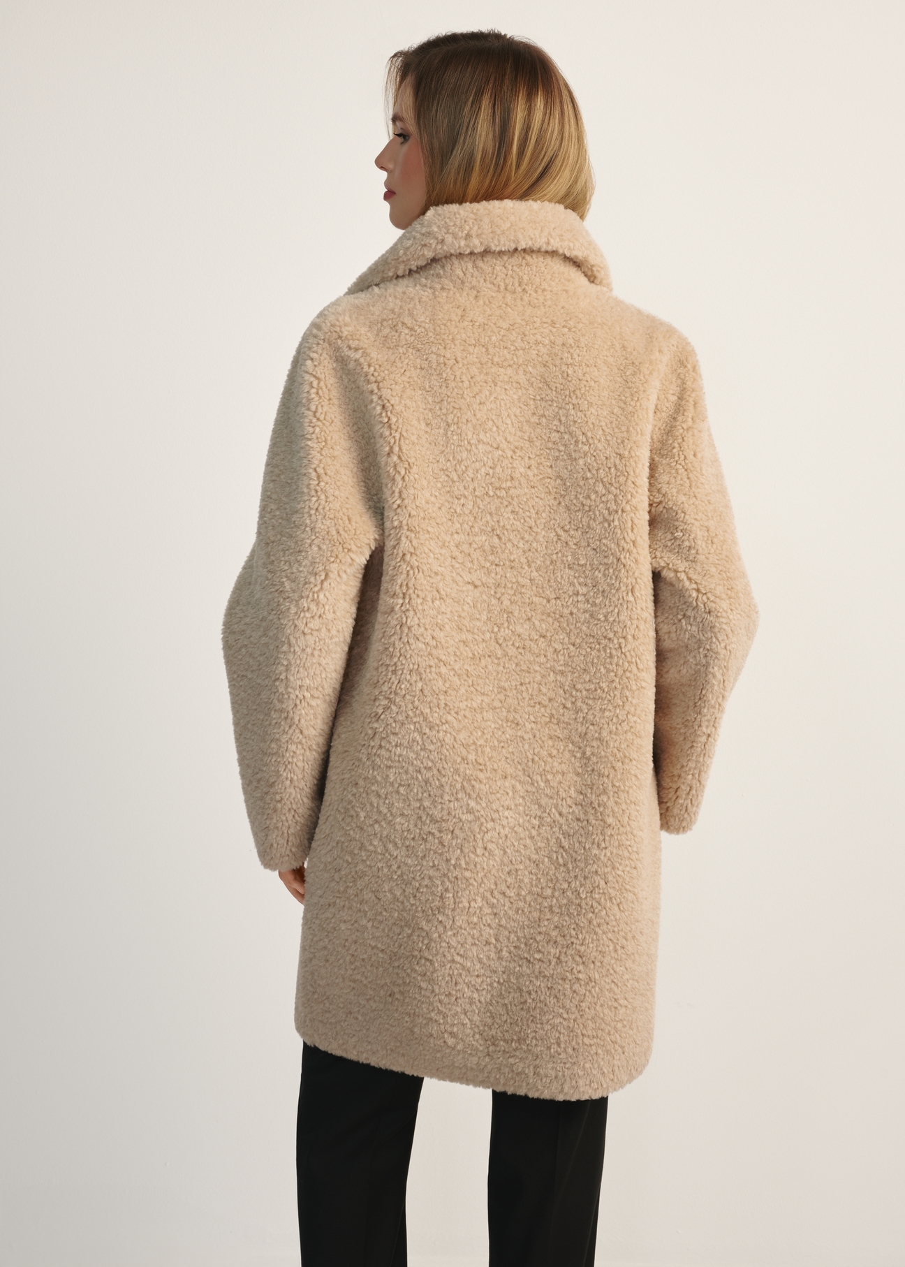 Women's fur coat with double-breasted fastening FUTDP-0018-81(Z25), product view from the back on the model, half of the silhouette visible.