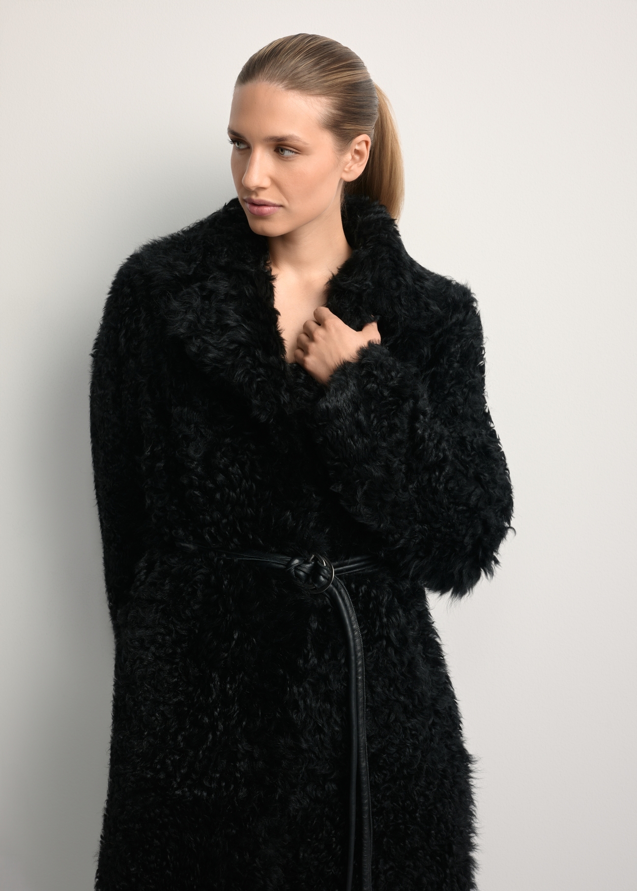Black double-sided women's sheepskin coat KOZDS-0091-1395(Z25), front view of the product on a model. Half of the silhouette visible.