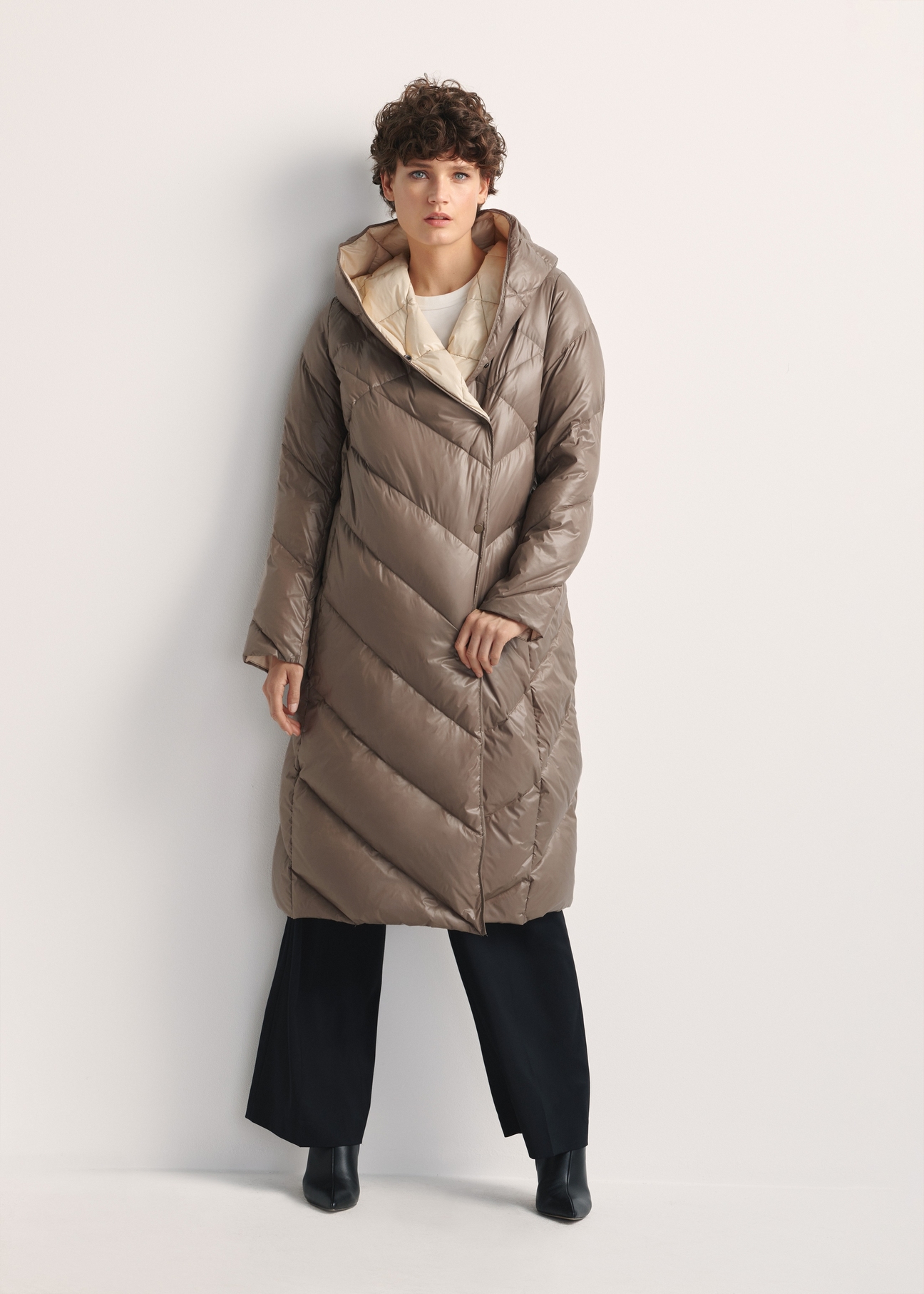 Long olive women's winter jacket KURDT-0542A-57(Z25), product view from the front on the model, the whole silhouette is visible.