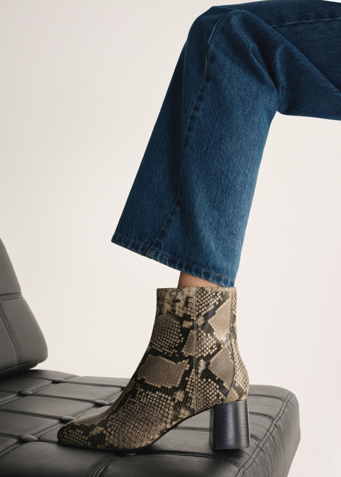 Leather high-heeled ankle boots with snakeskin motif BUTYD-1218-86(Z25), view of the product on the model's foot.