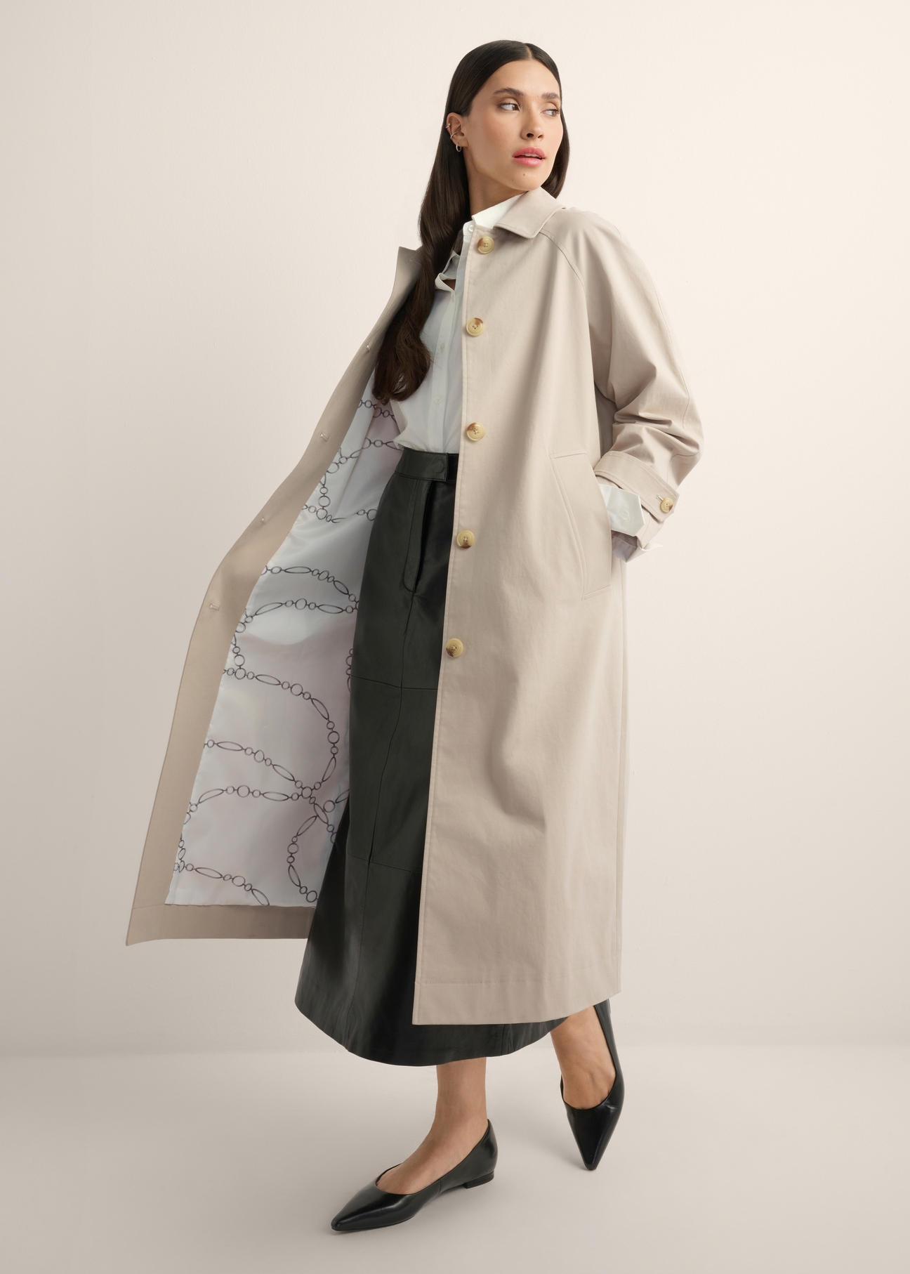 Long beige women's coat KURDT-0692-1J(Z26), product view from the side on the model, the whole silhouette is visible.
