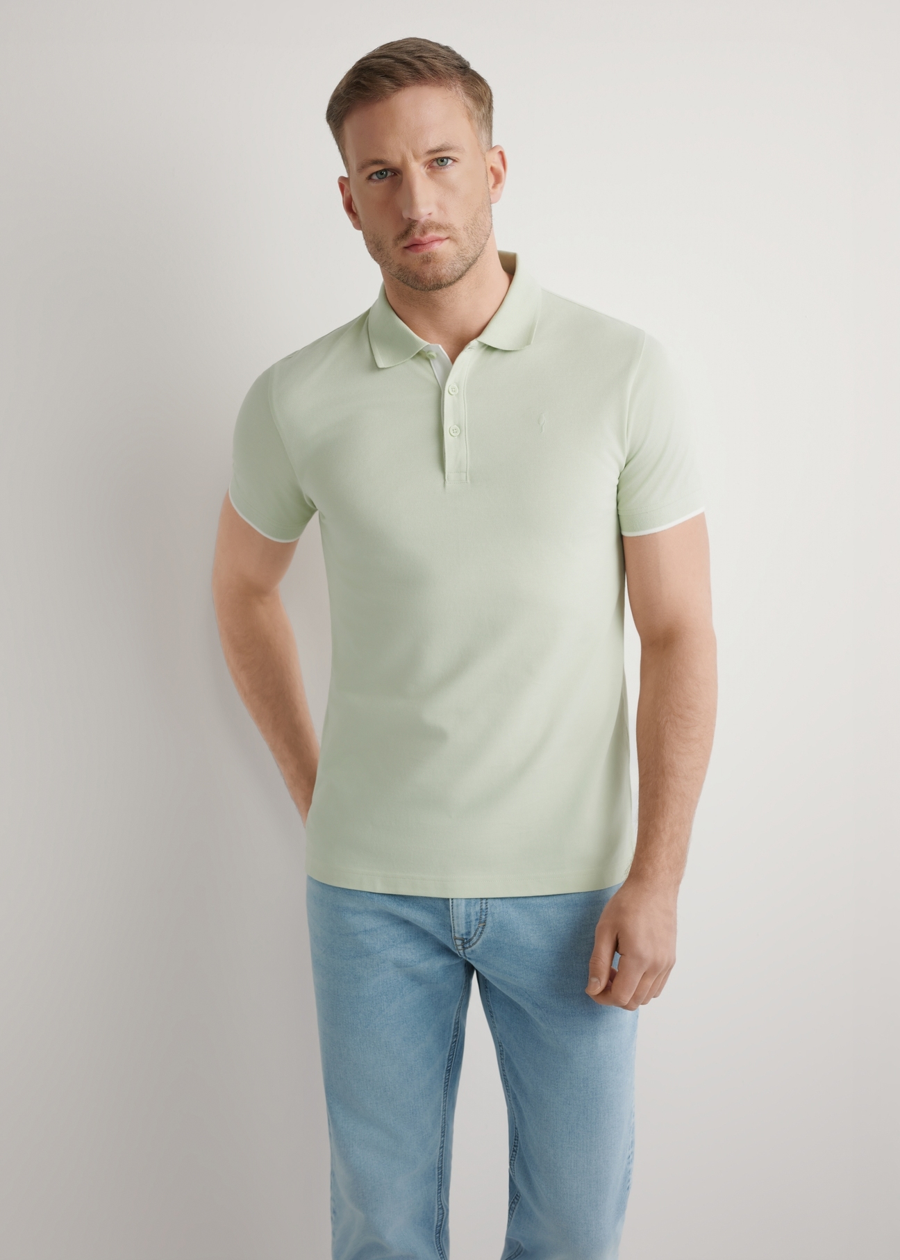 Sage cotton polo shirt POLMT-0045B-8F(W26), front view of the product on the model. Half of the silhouette visible.