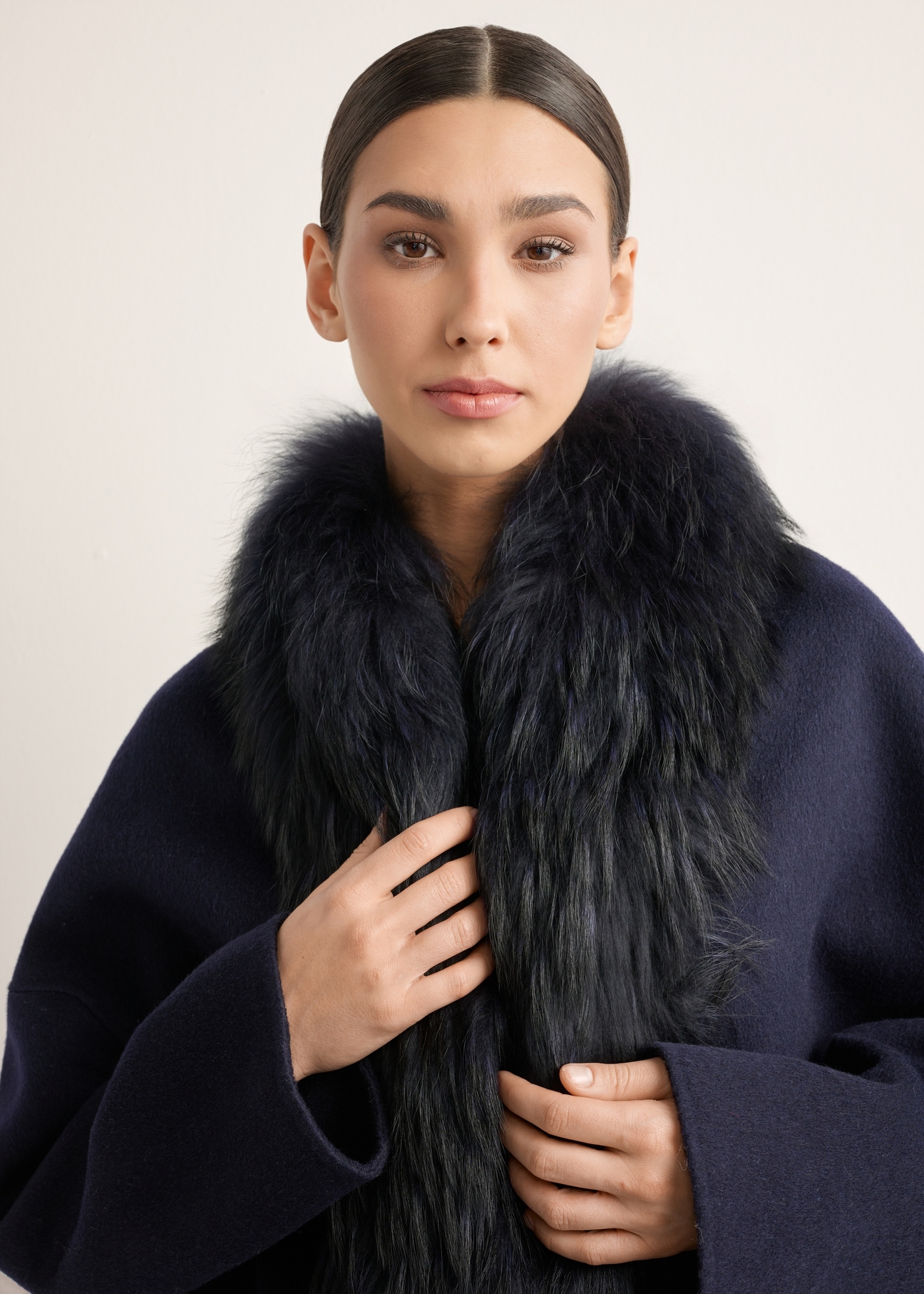 Short woolen women's fur coat in navy blue FUTDW-0038-7E(Z26), close-up of the product on the model's silhouette.