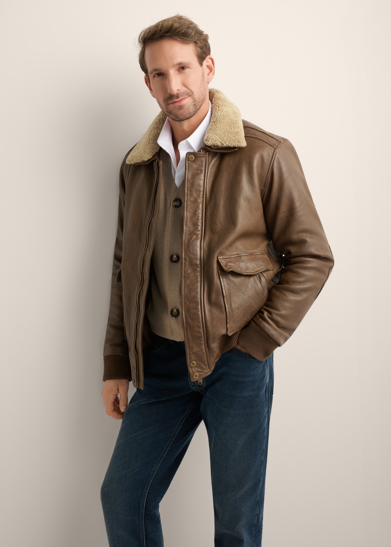 Men's brown leather bomber jacket KURMS-0424-1K(Z26), front product view on model. Half silhouette visible.