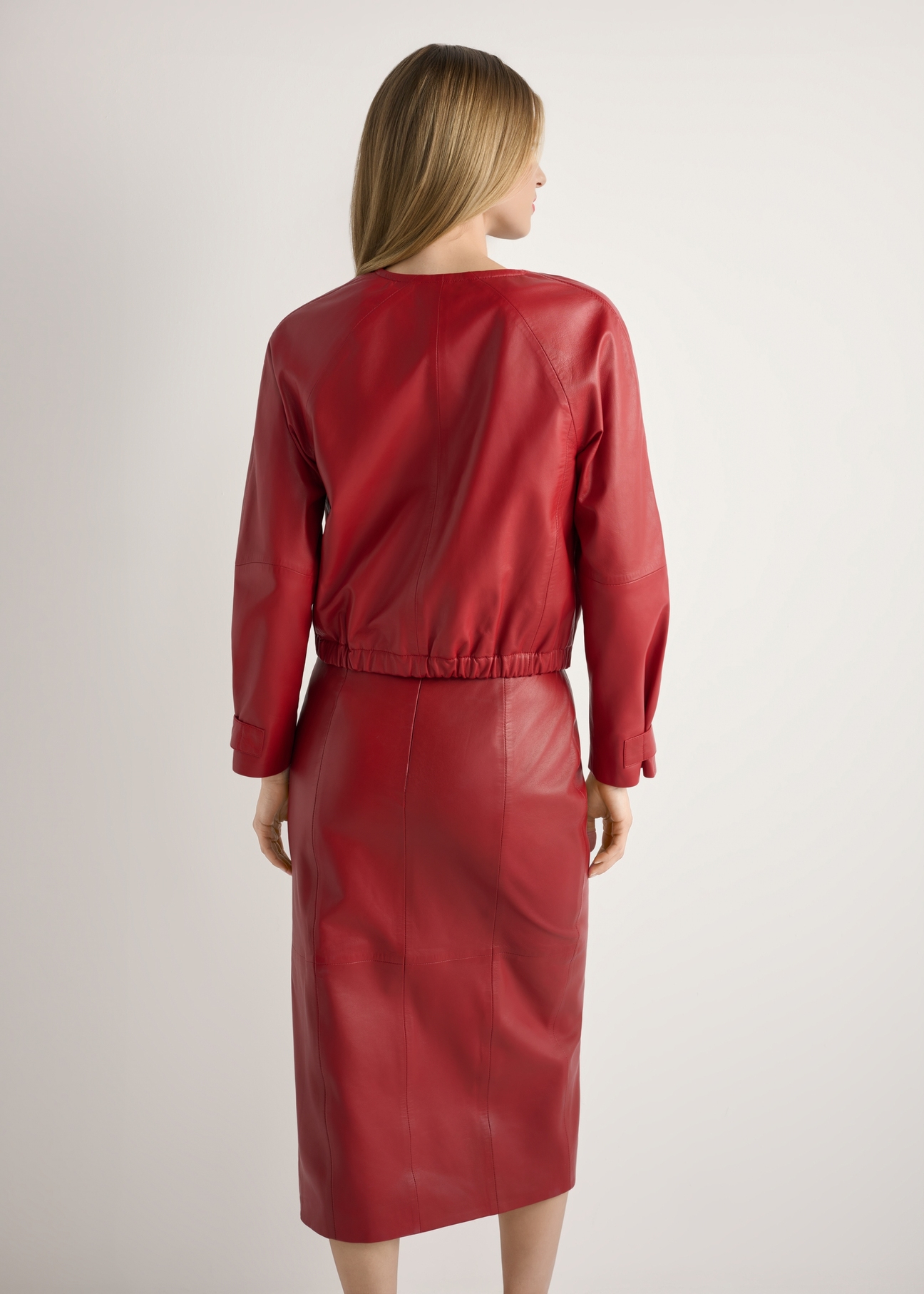 Women's red leather jacket KURDS-0588-4B(W26), back view of the product on the model. Half of the silhouette visible.