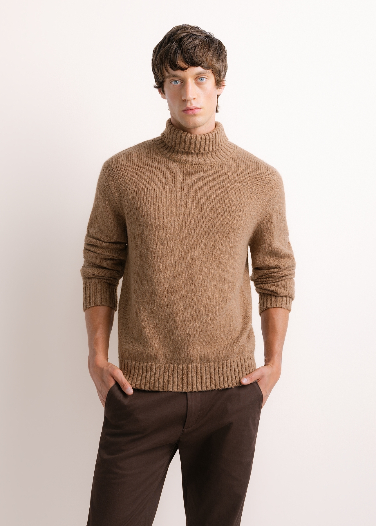 Men's turtleneck sweater in camel color SWEMT-0209-1D(Z26), front view of the product on the model. Half of the silhouette visible.
