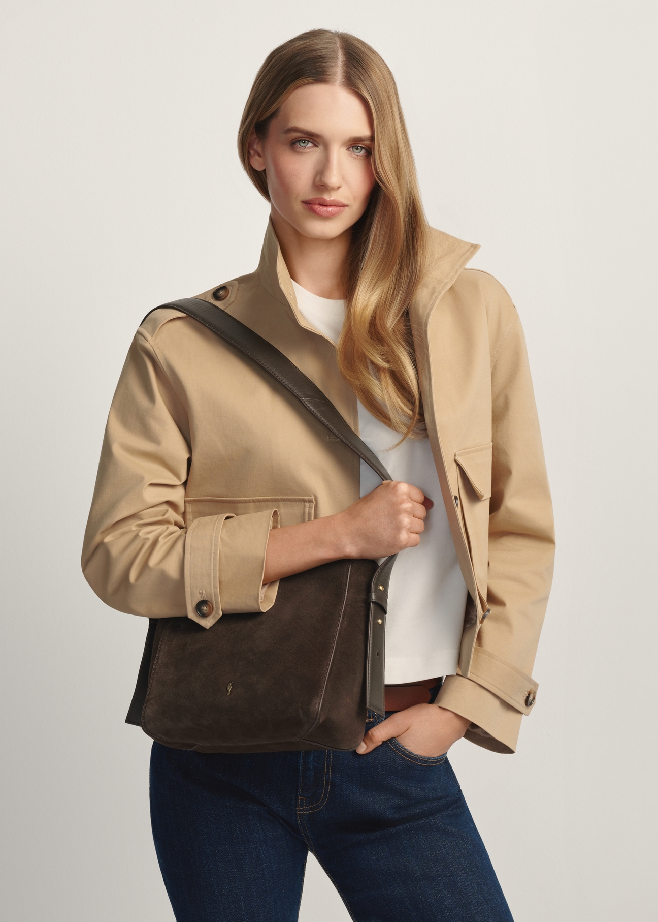 Women's brown leather handbag TORES-1251-1I(W26) - diagonal view of the product, on a model, against a light background. Knee-length silhouette visible.