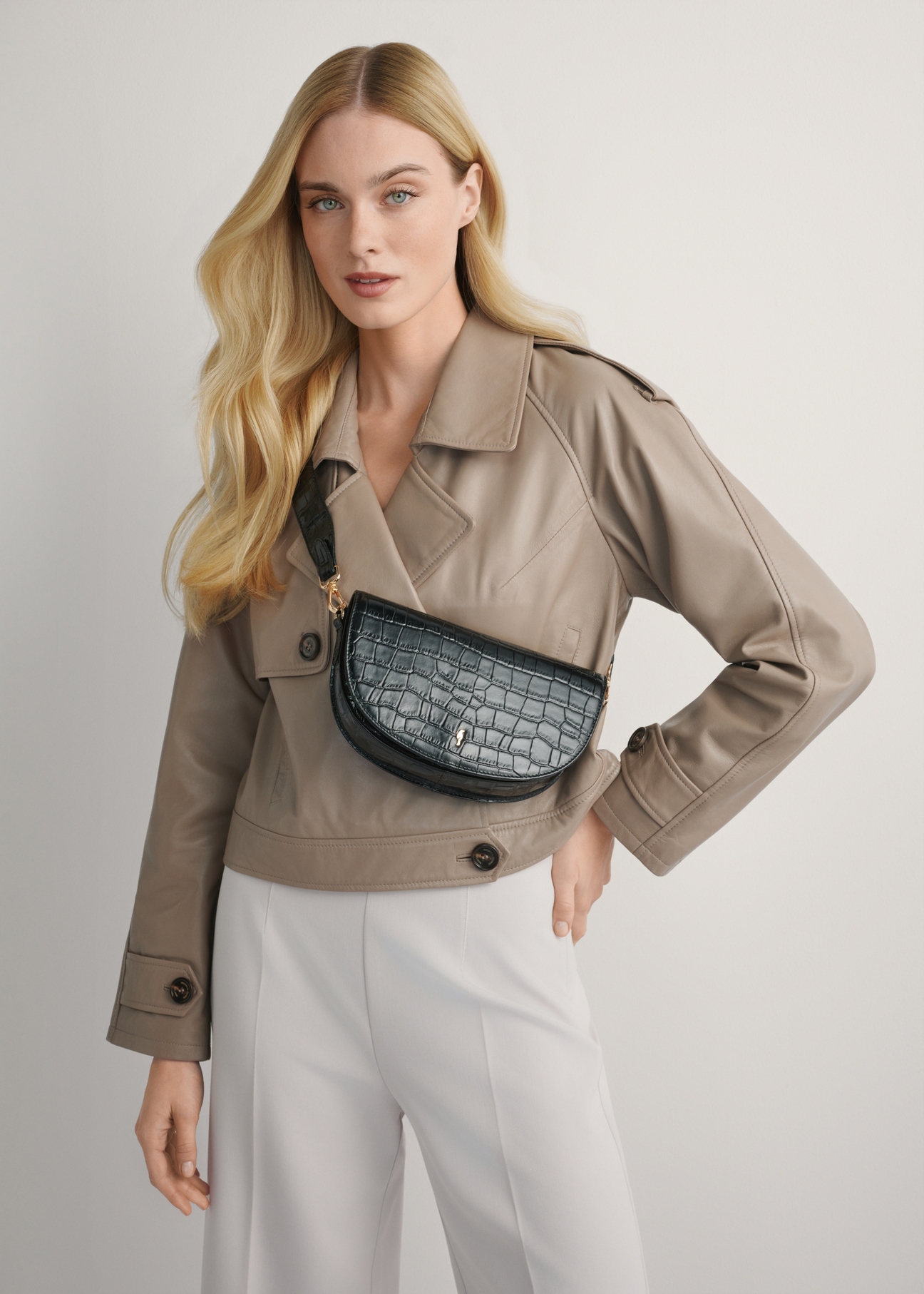 Black leather half-round croco messenger bag TORES-1230-9G(W26), product view on model's shoulder. Half silhouette visible.