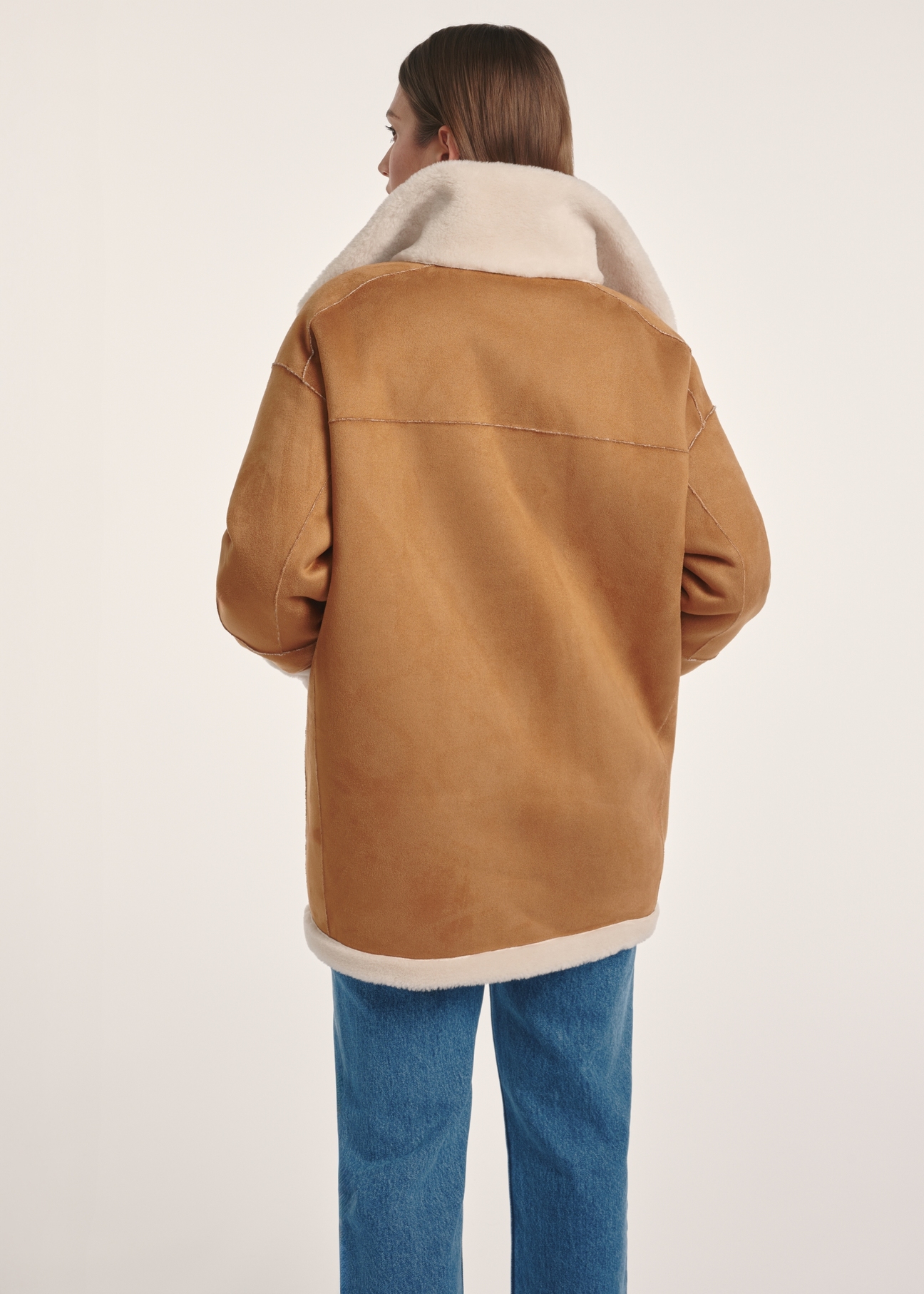 Women's double-sided sheepskin coat KOZDP-0009-24(Z24), view of the product from the back on the model, half of the silhouette visible.