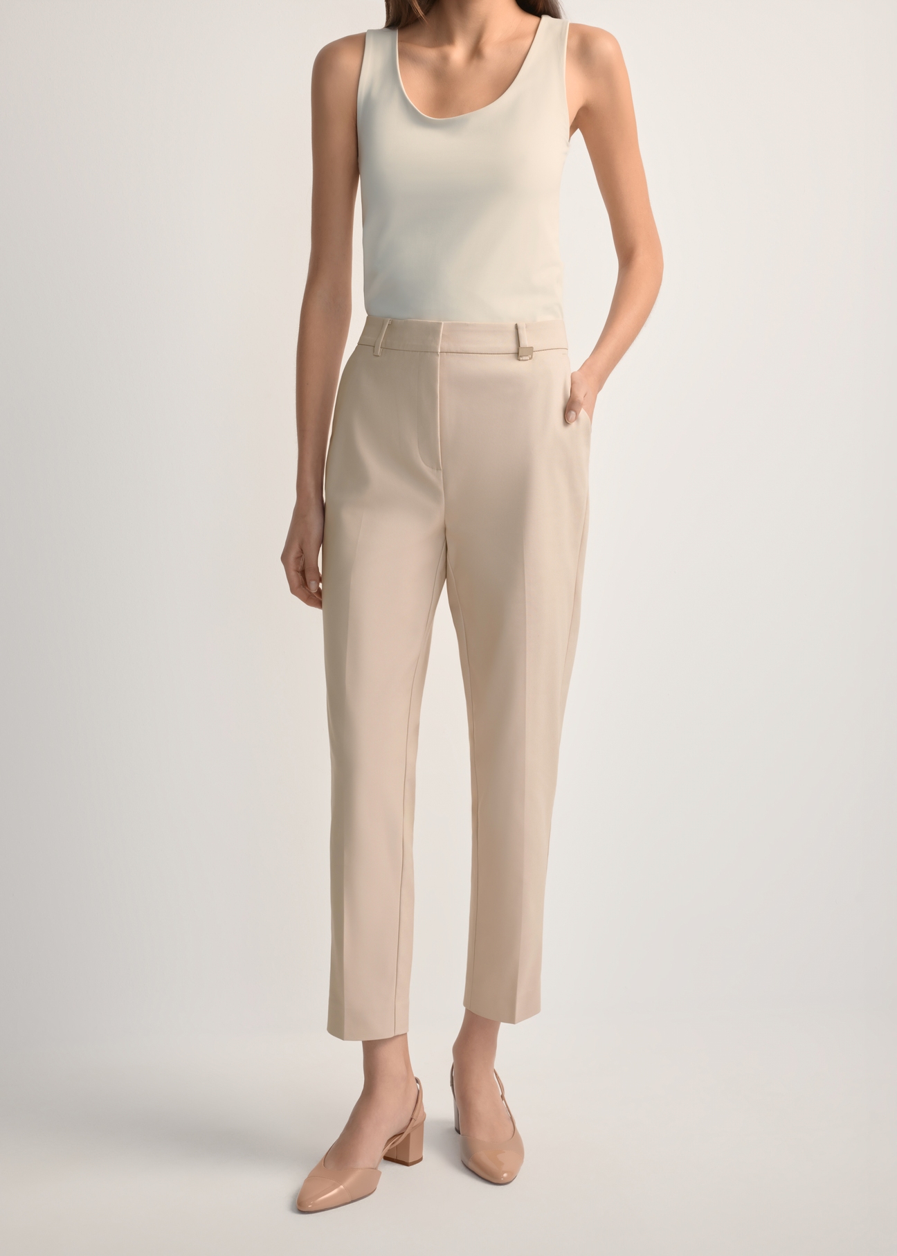 Beige women's pleated trousers SPODT-0090-1B(W26), front view of the product on the model. Half of the silhouette visible.