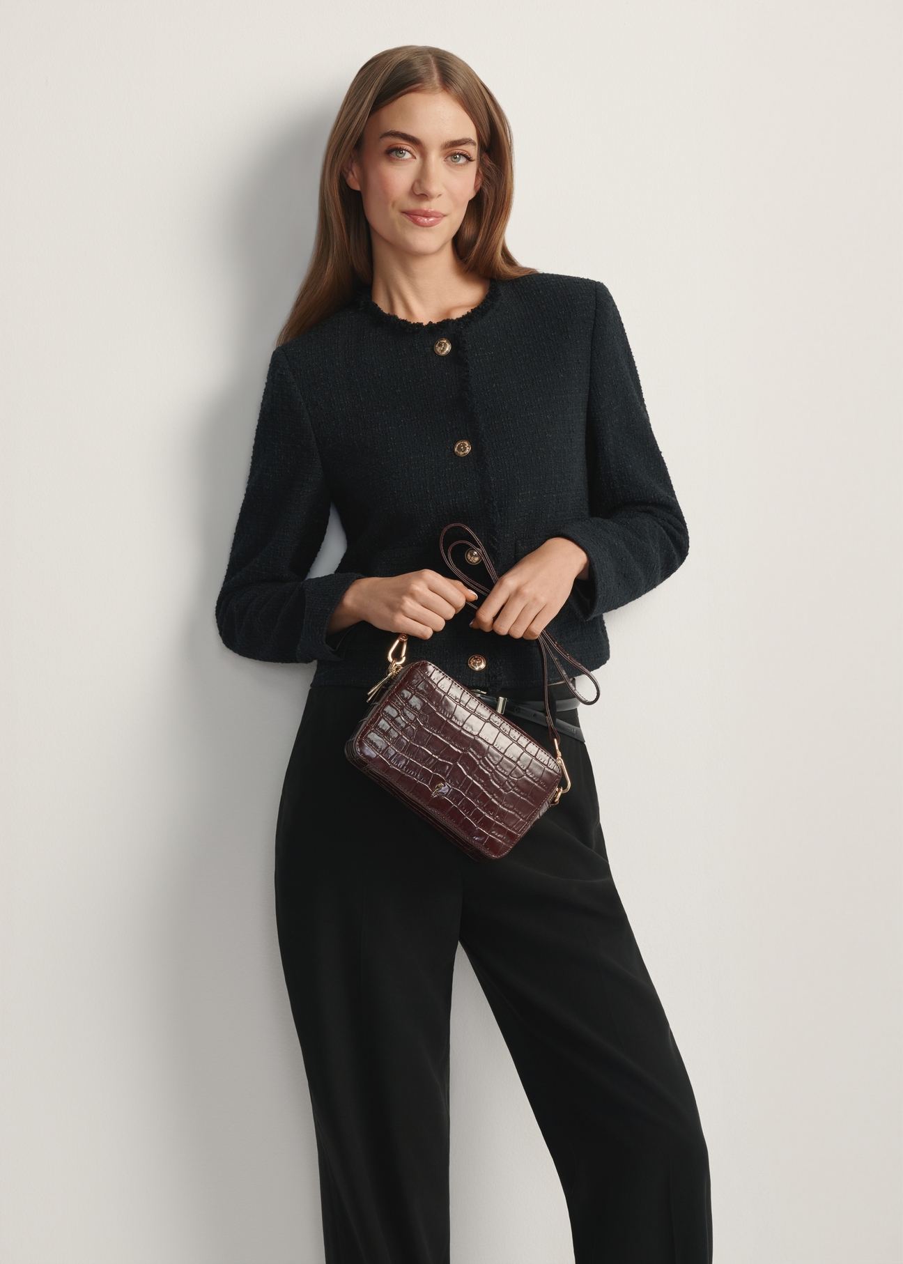 Small brown crocodile leather handbag TORES-1231-1H(W26) - front view of the product, on a model, against a light background. Knee-length silhouette visible.