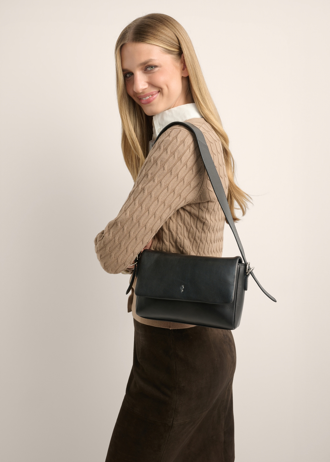 Black leather women's handbag TORES-1377-99(Z26), front view of the product on a model. Half of the silhouette visible.