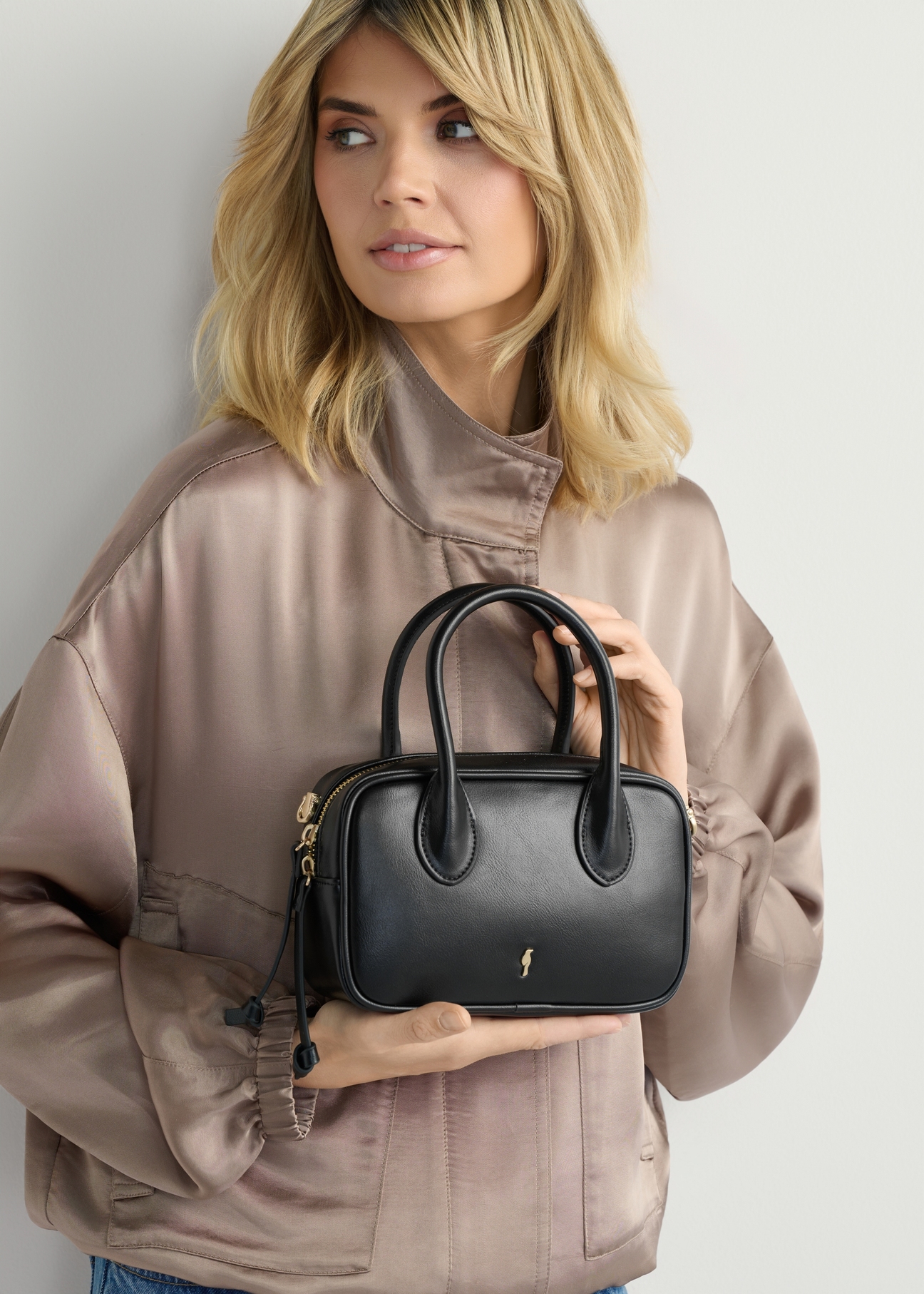 Small black women's handbag TOREC-1234-9G(W26), front view of the product in the model's hands.