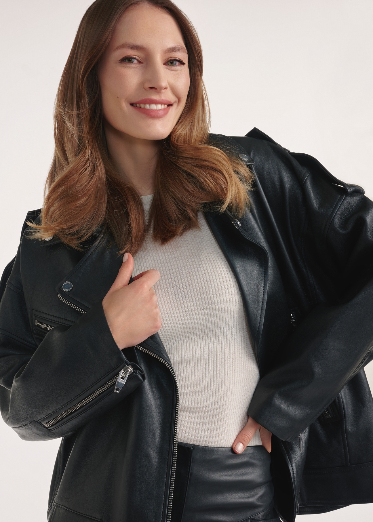 Black oversize women's leather jacket KURDS-0555-2878(Z25), front view of the product on the model, 1/3 of the silhouette visible.