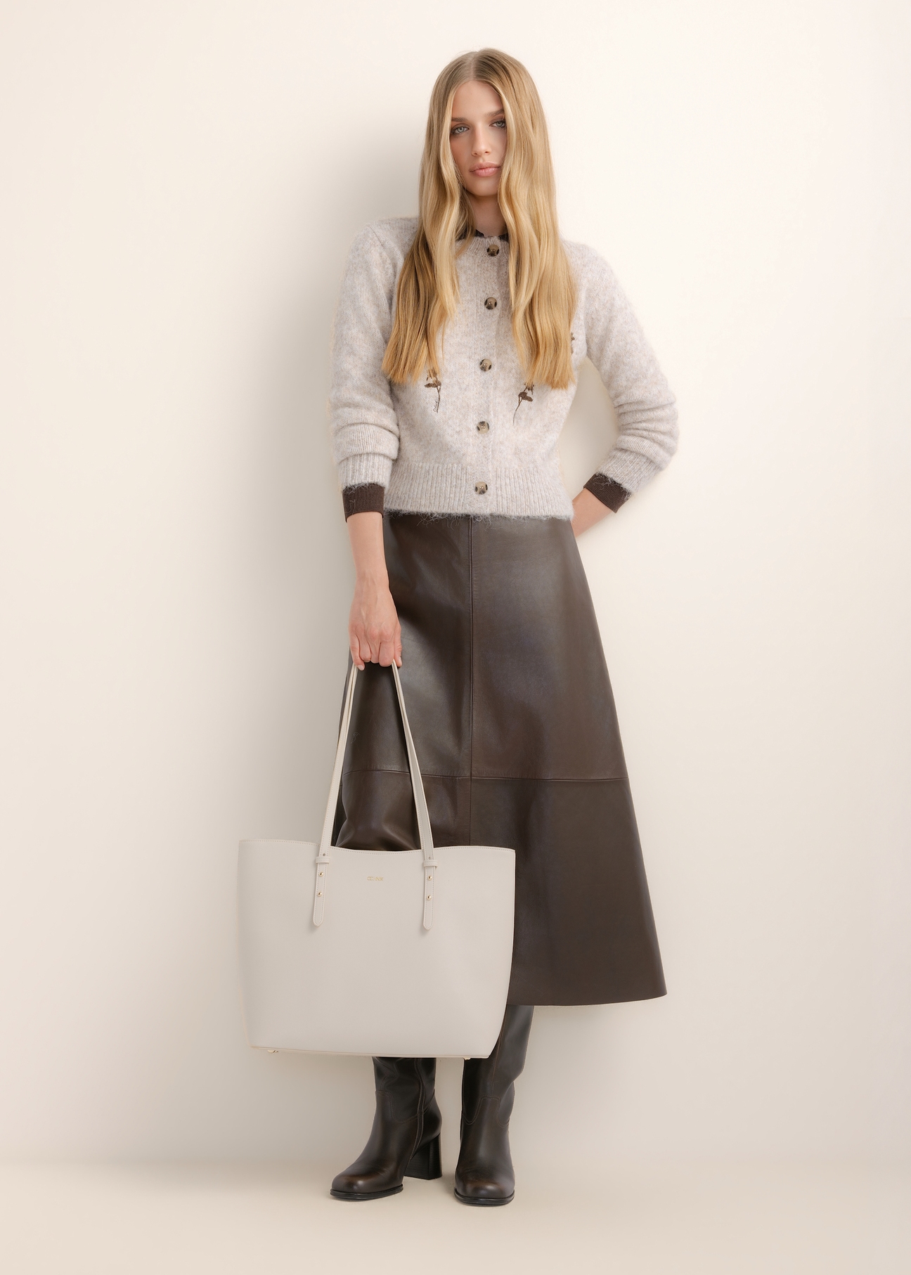 Large cream women's shopper bag TOREC-1309-0B(Z26), front view of the product, on a model, on a light background. The entire silhouette is visible.