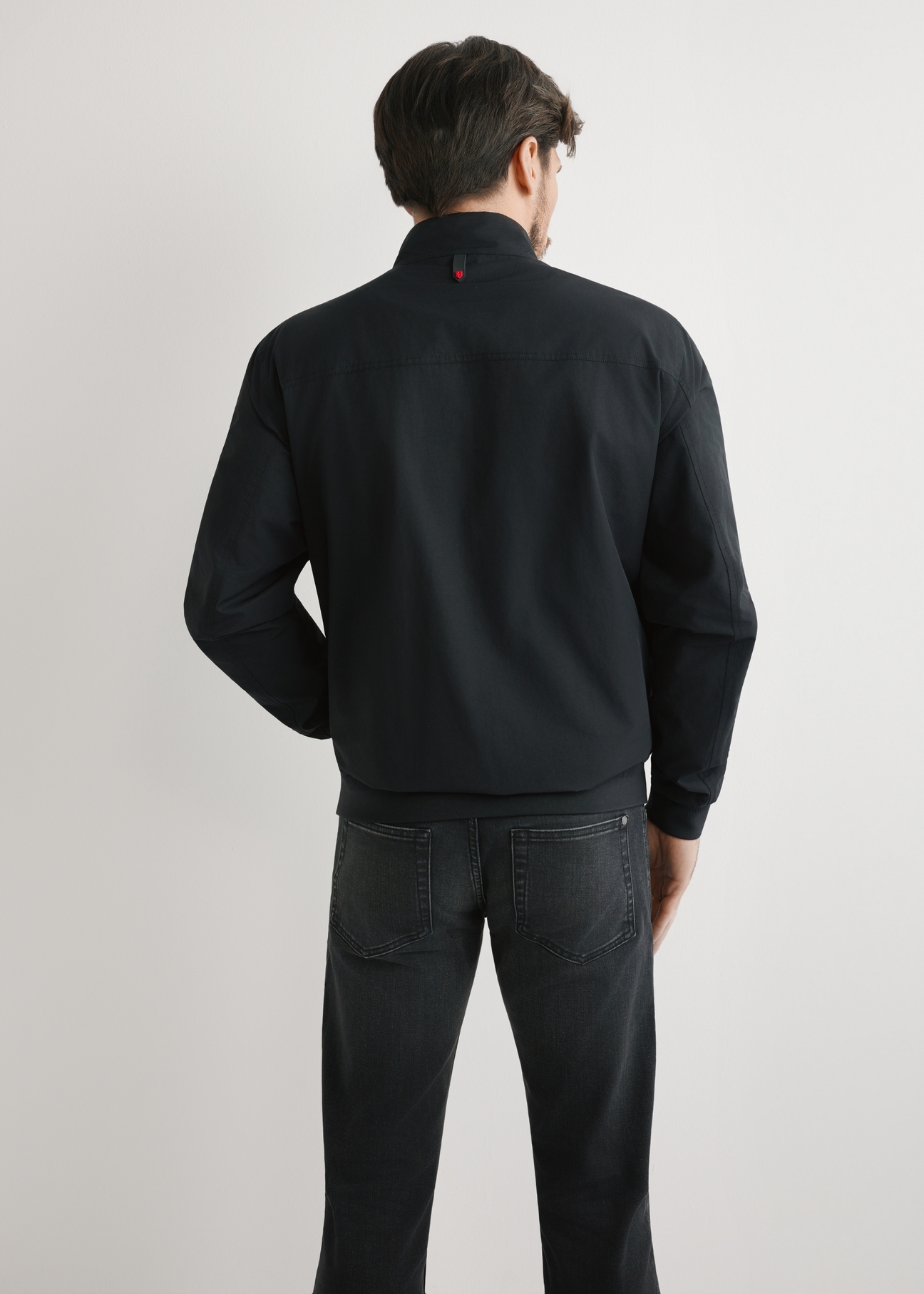 Men's black lightweight transitional jacket KURMT-0370-99(W25), product view from the back on the model. Half of the silhouette visible.