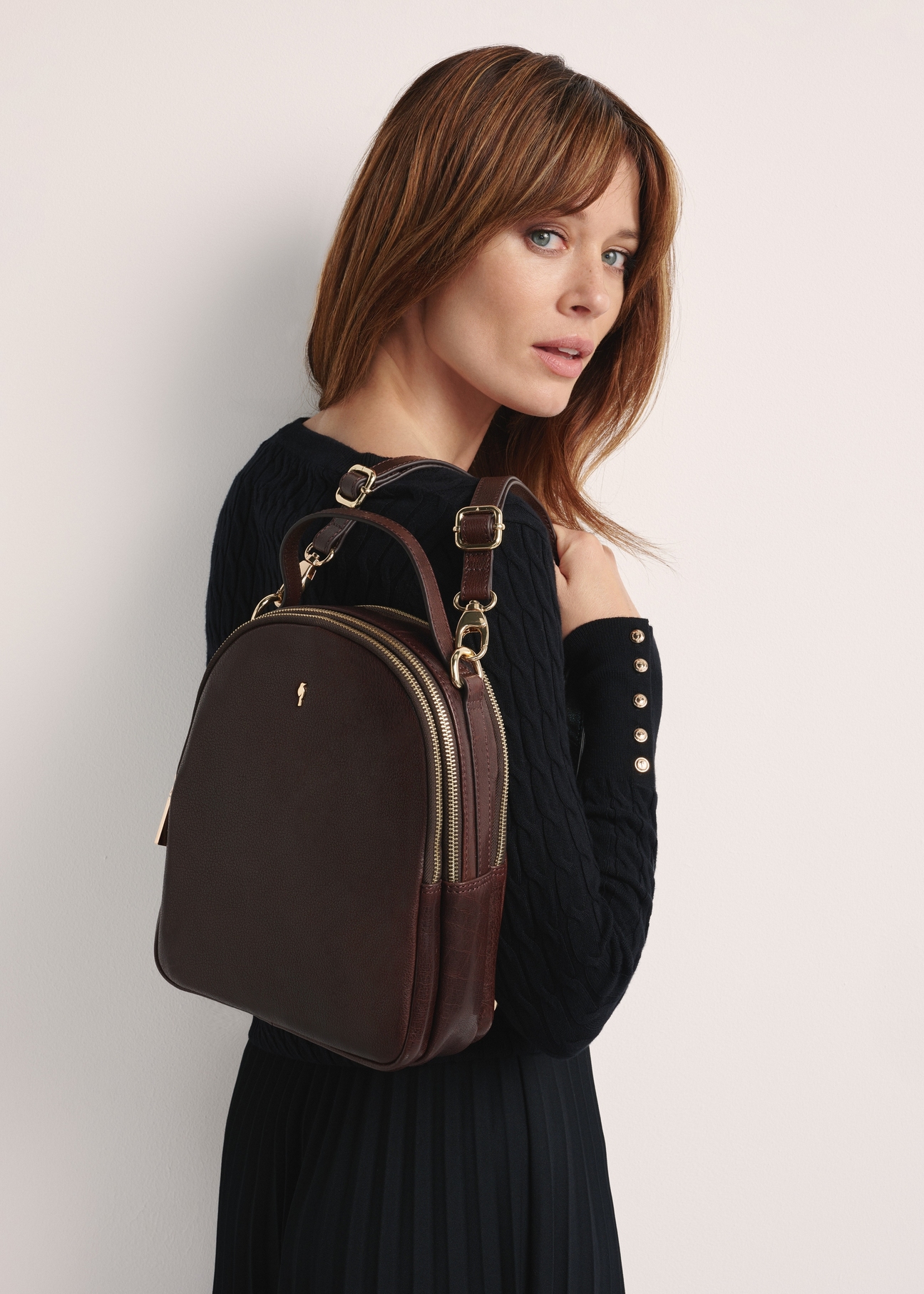 Brown leather women's backpack TORES-1048A-89(Z25) - product view slightly diagonal on model against white background. Half of silhouette visible.