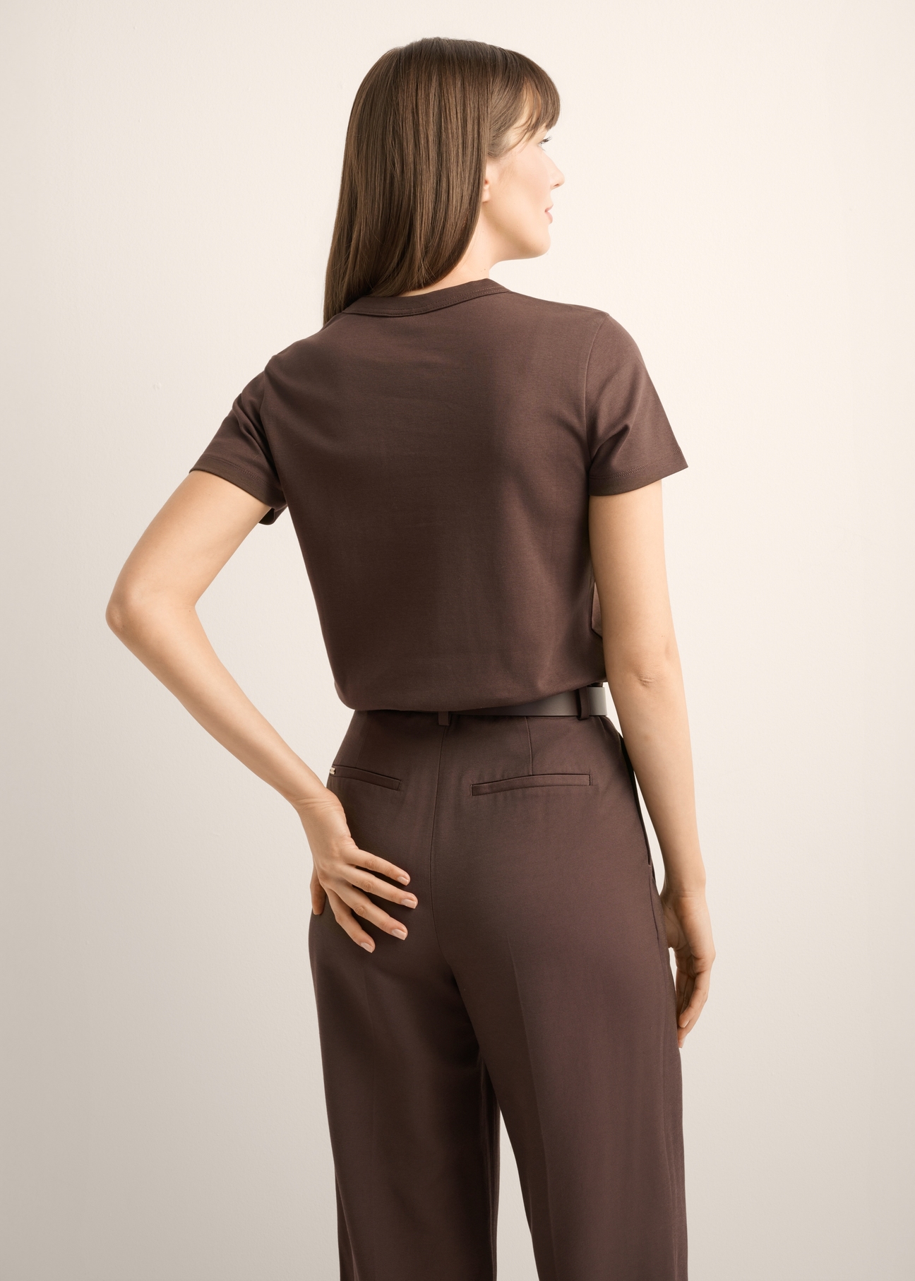 Dark brown cotton women's T-shirt TSHDT-0144-1I(Z26), back view of the product on the model. Half of the silhouette visible.