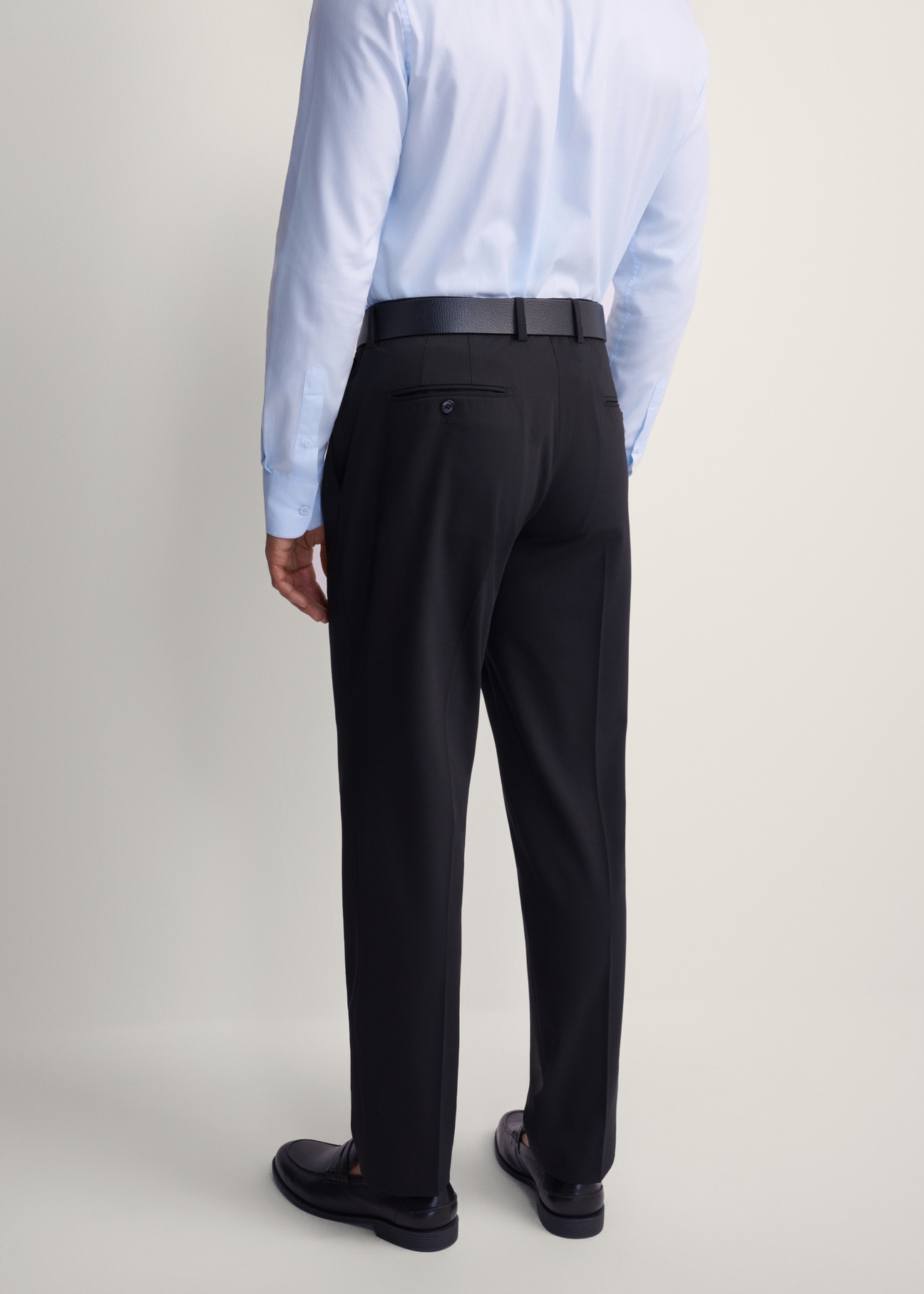 Black men's suit trousers SPOMT-0113-99(Z25), product view from the back on the model, half of the silhouette visible.