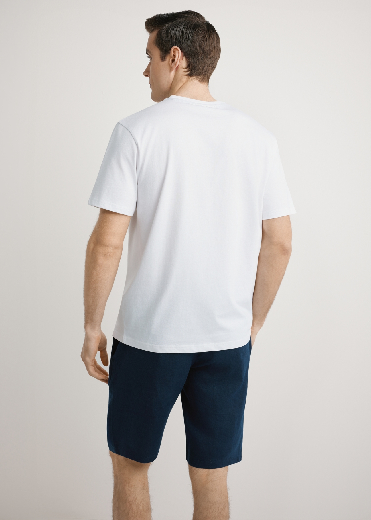 Men's white T-shirt with print TSHMT-0145-0A(W26), back view of the product on the model. Half of the silhouette visible.