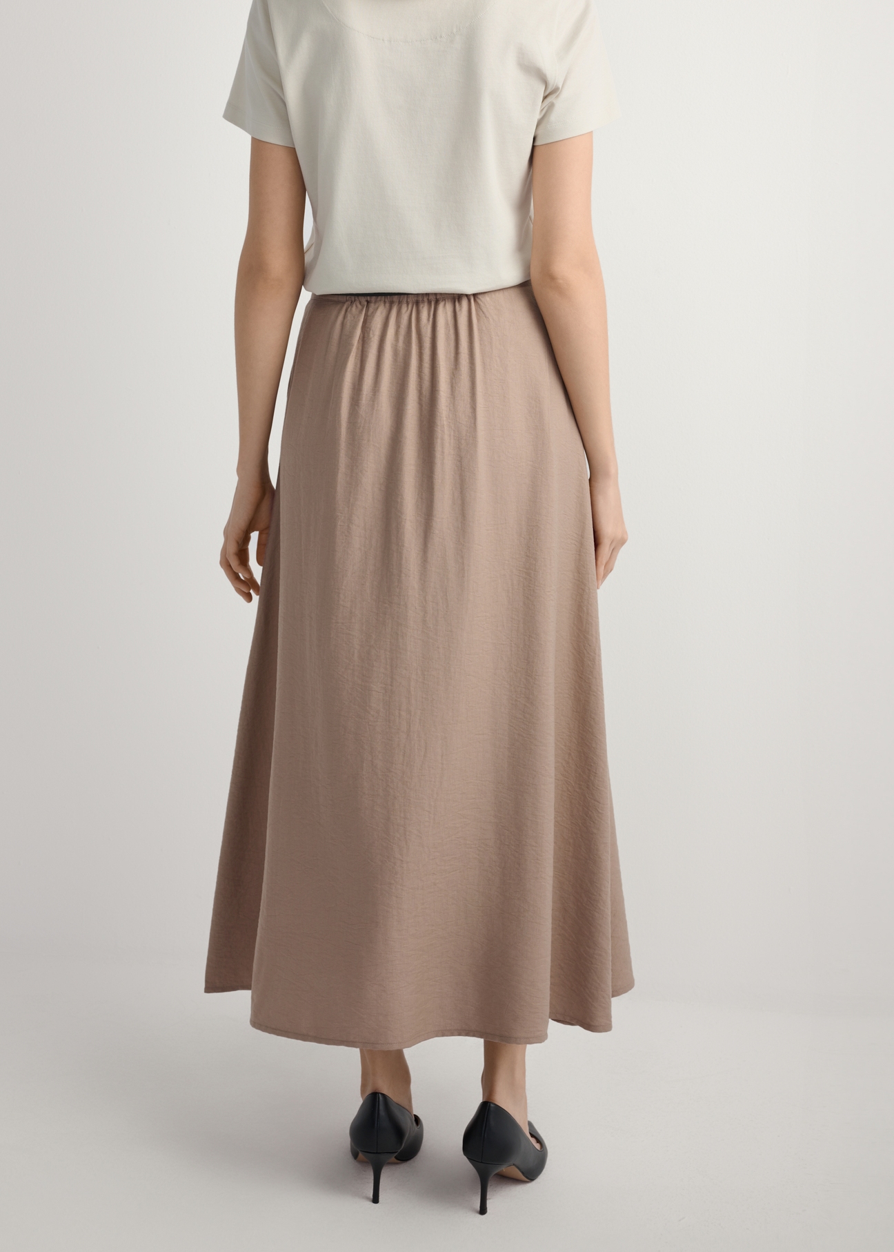 Beige viscose midi skirt SPCDT-0121-1D(W26), back view of the product on the model. Half of the silhouette visible.