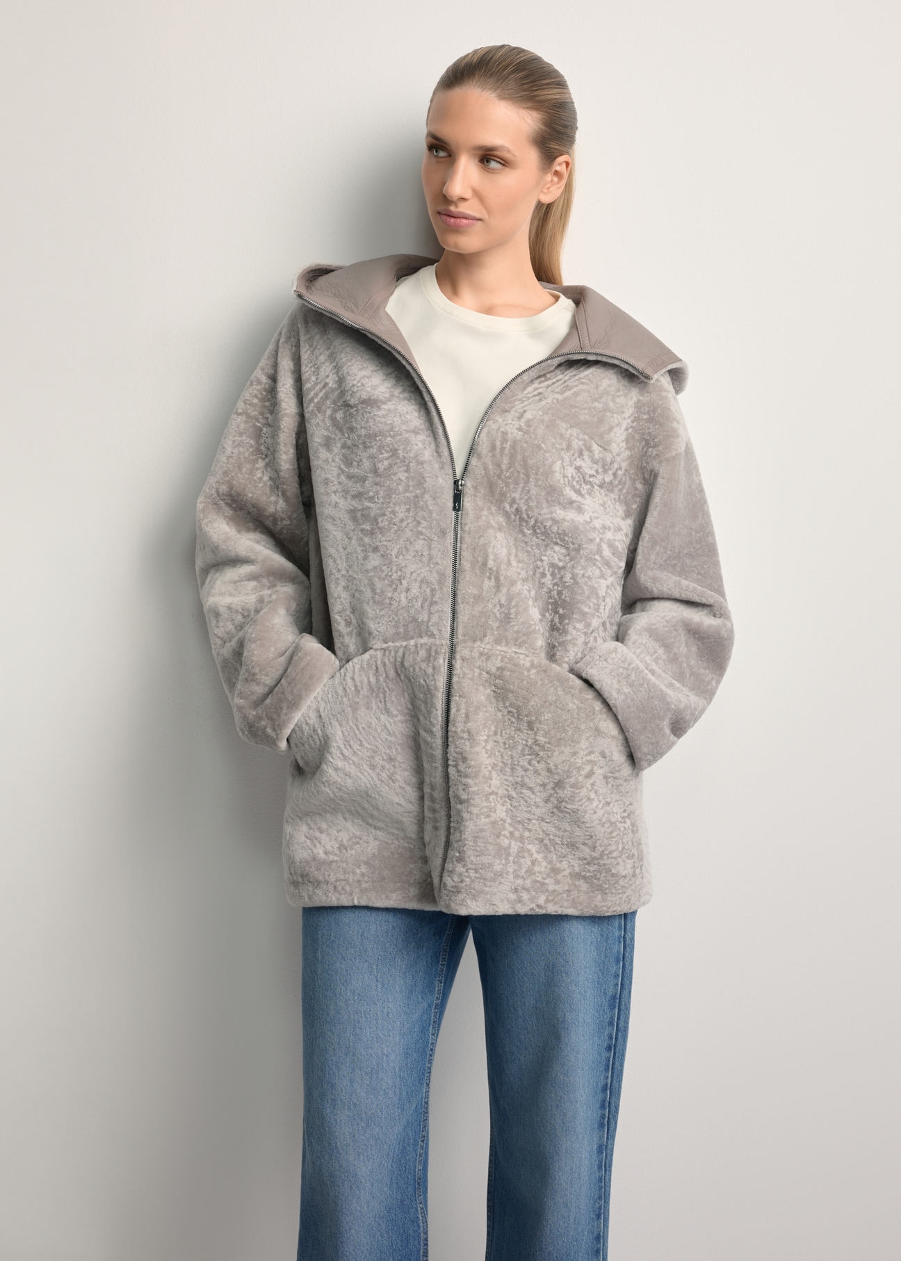 Light gray women's sheepskin coat KOZDS-0092-3098(Z25), front view of the product on a model. Half of the silhouette visible.