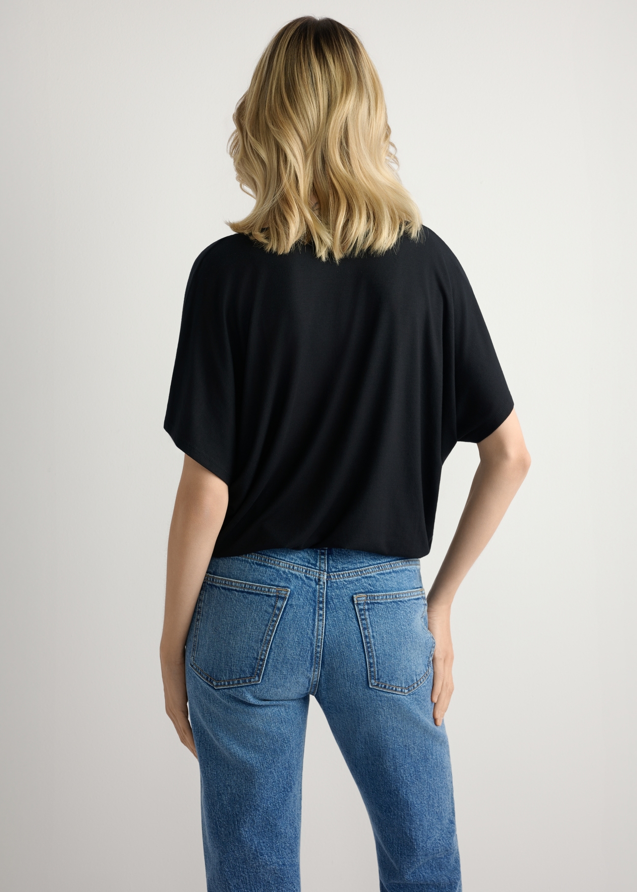 Black women's blouse BLUDT-0202-99(W26), back view of the product on the model. Half of the silhouette visible.