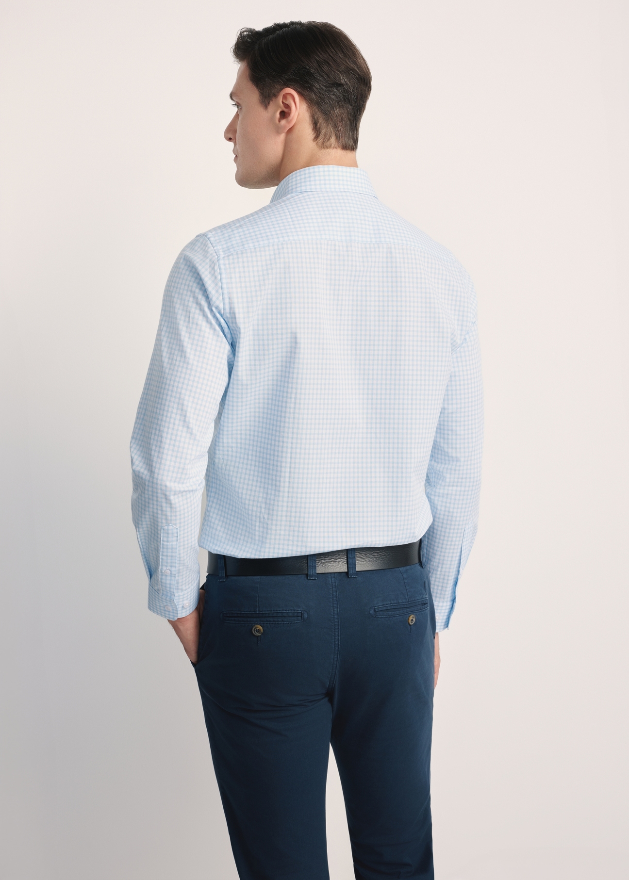 Men's cotton shirt in light blue checkered pattern KOSMT-0277-58(Z25), product view from the back on the model, half of the silhouette visible.