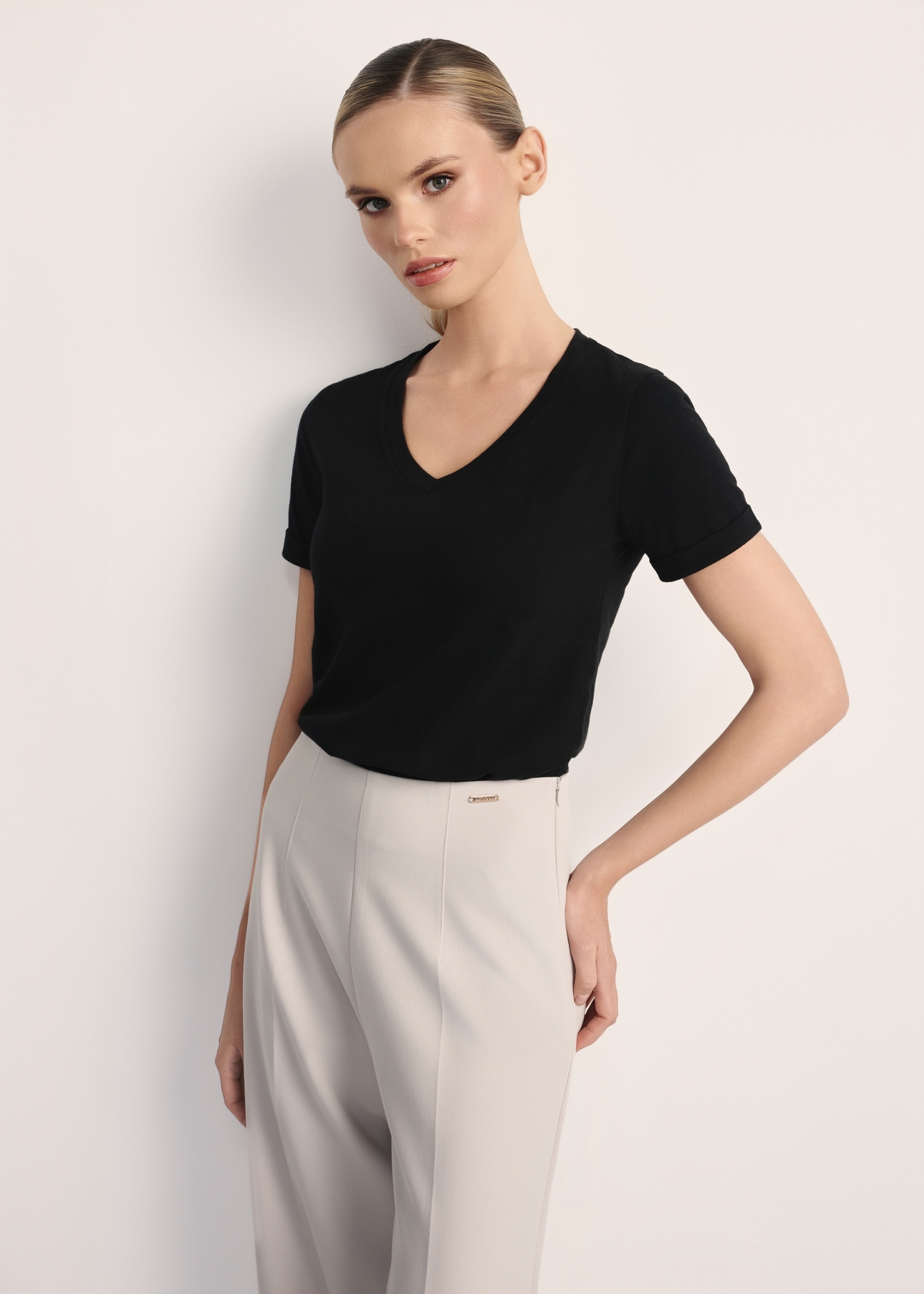 Black women's V-neck T-shirt TSHDT-0118A-99(Z25), front view of the product on the model. Half of the silhouette visible.