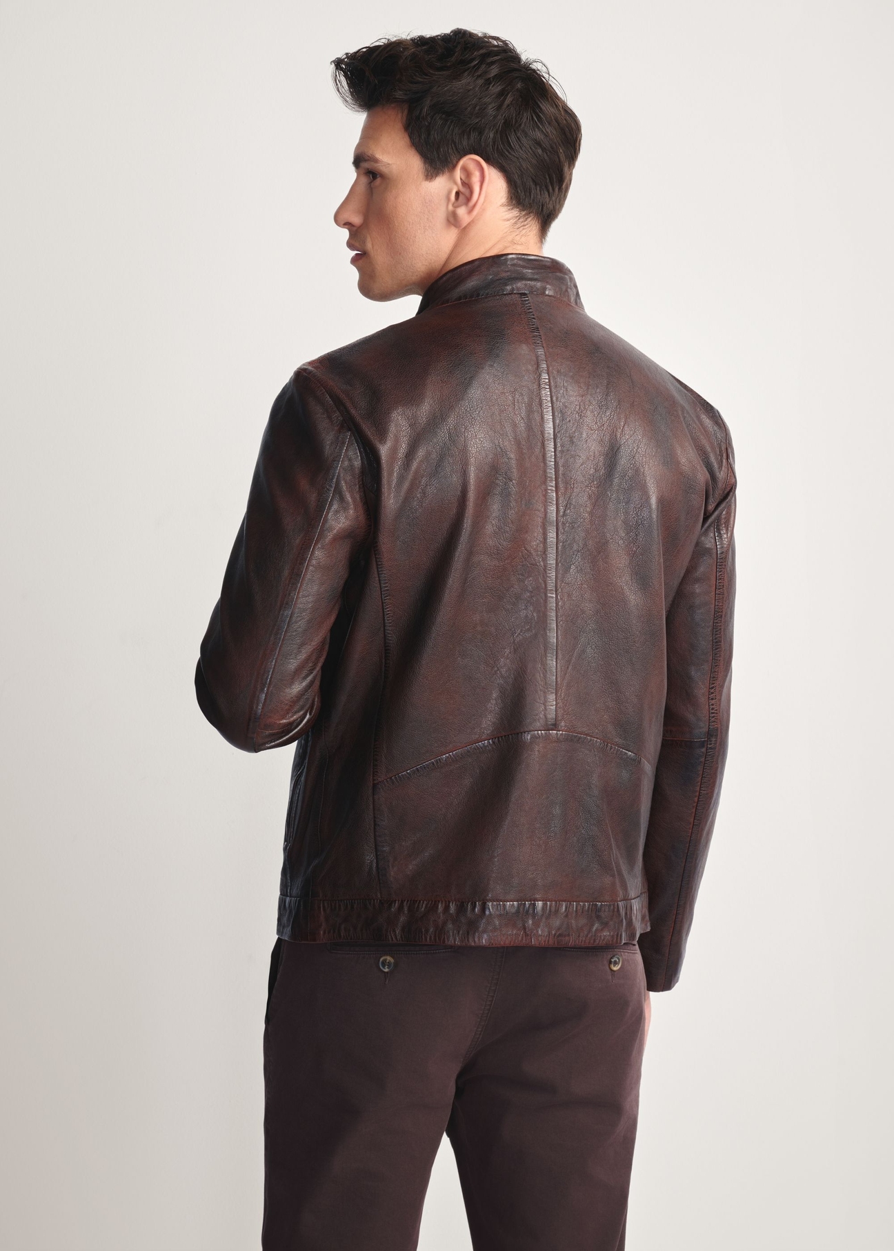 Brown men's leather jacket KURMS-0384-3340(Z25), product view from the back on the model, half of the silhouette visible.