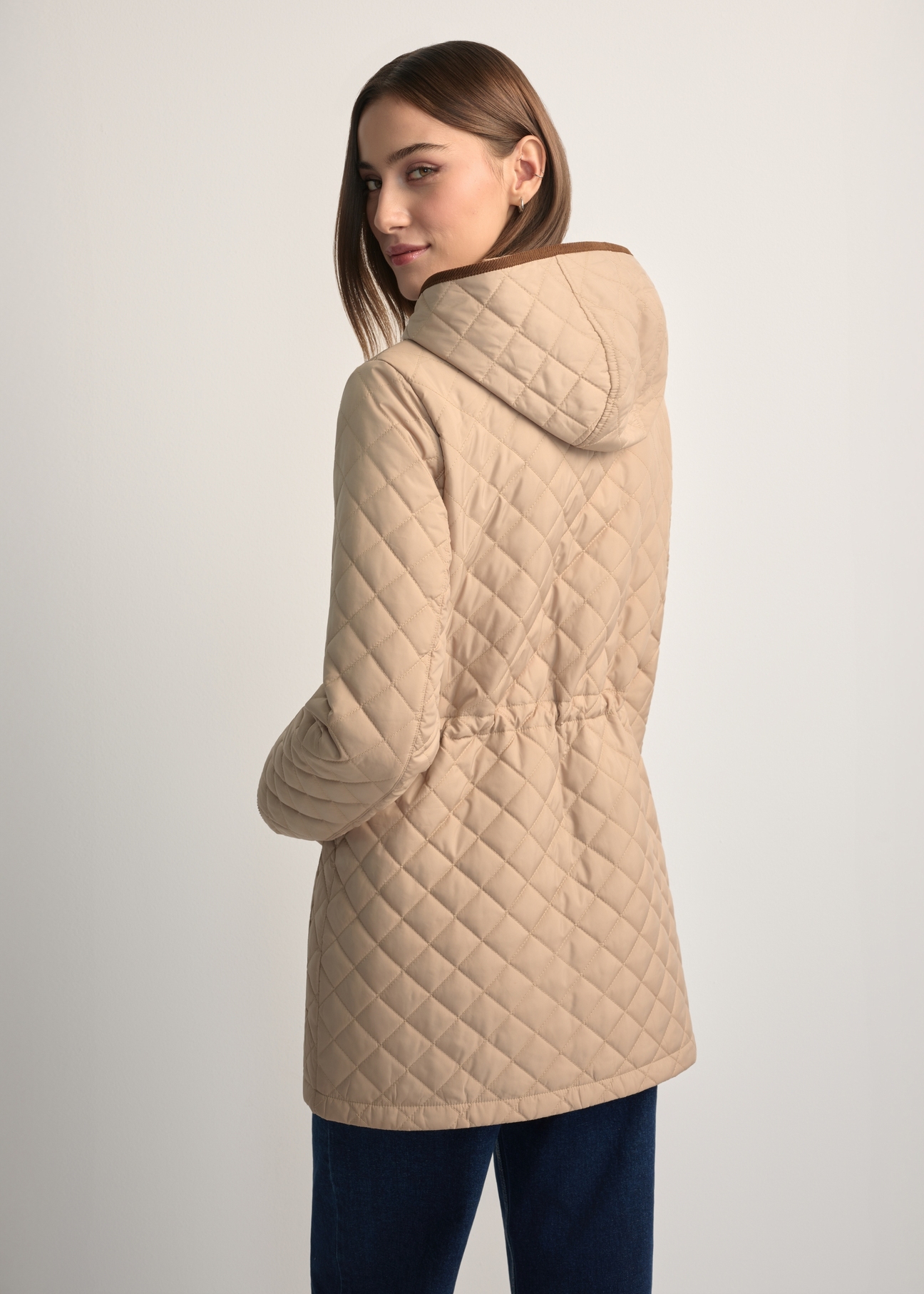 Beige women's quilted jacket KURDT-0646-1B(W26), back view of the product on the model. Half of the silhouette visible.