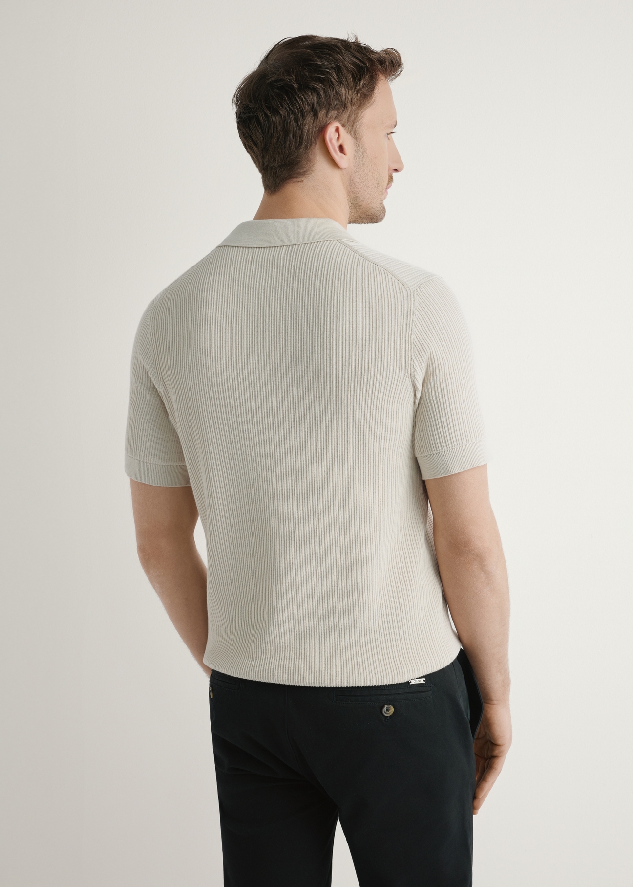 Light beige ribbed polo shirt POLMT-0085-1A(W26), back view of the product on the model. Half of the silhouette visible.