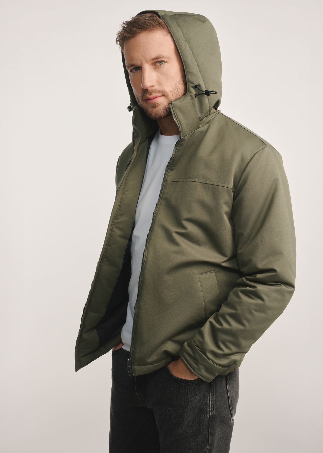 Men's khaki jacket KURMT-0386-54(Z25) - side view of the product on a model on a white background. Knee-length silhouette visible.